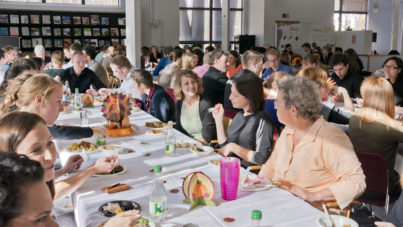 Sasakians conversing and eating during Sasaki's Annual Thanksgiving Potluck