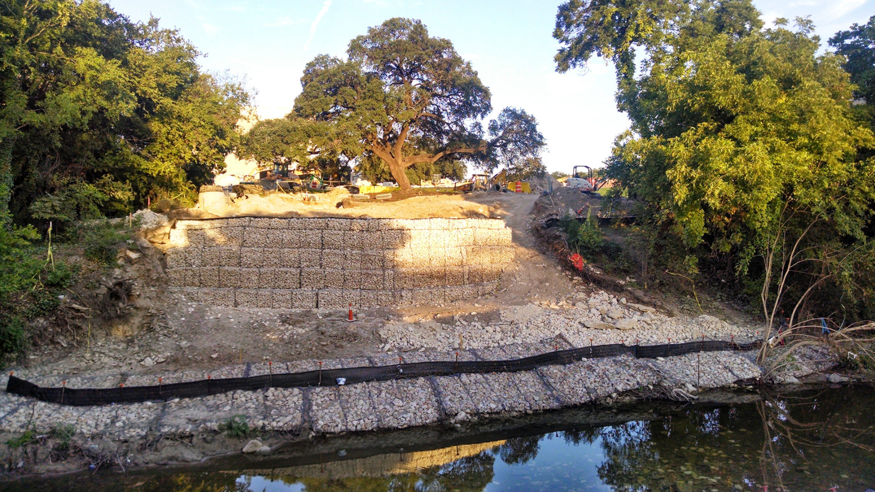 view over creek with tree on a hill