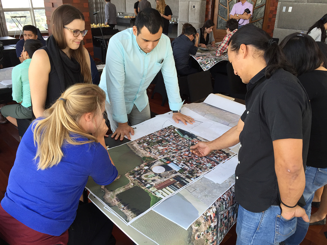 photo of people looking at a map