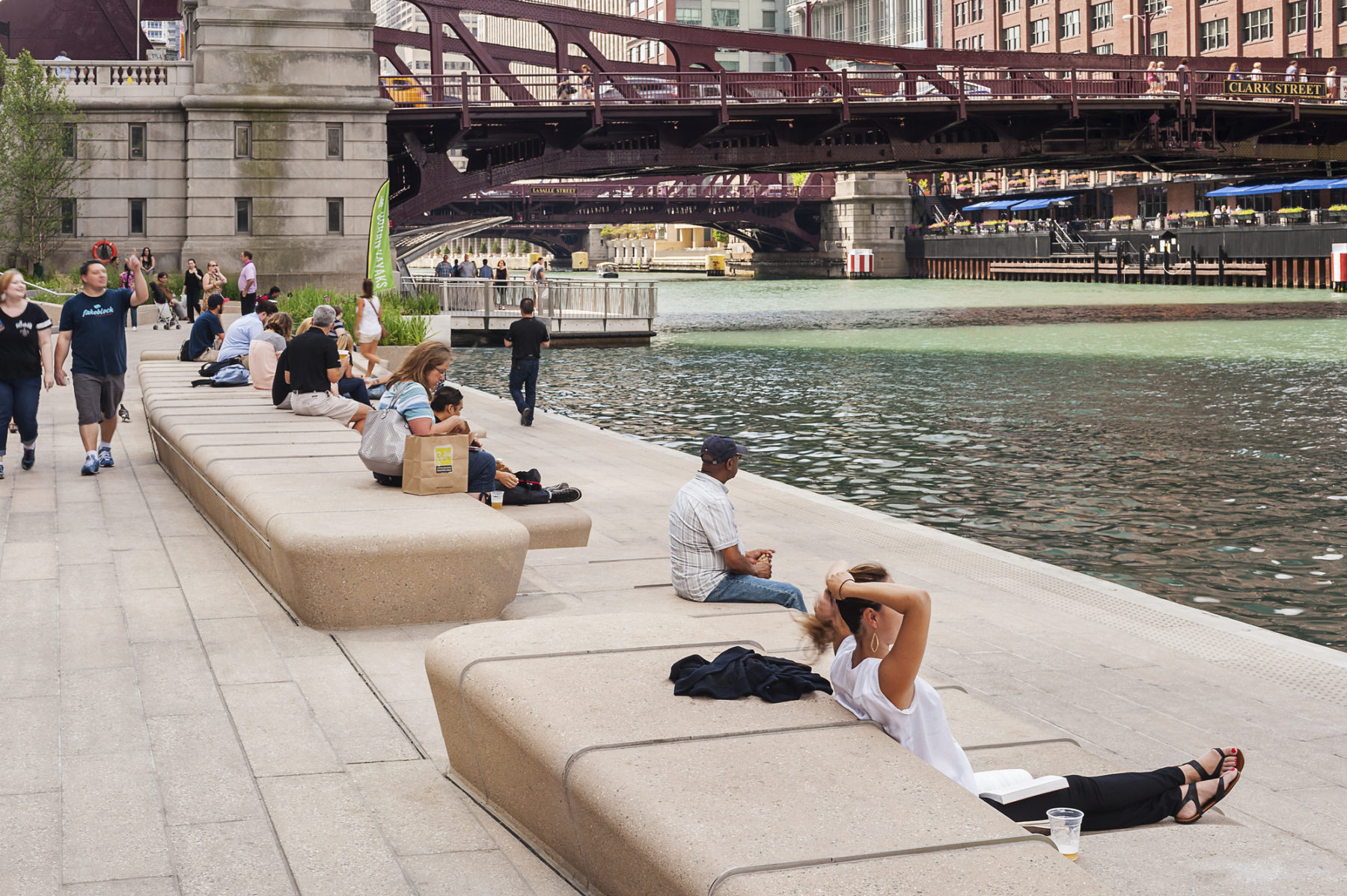 people sitting along a river