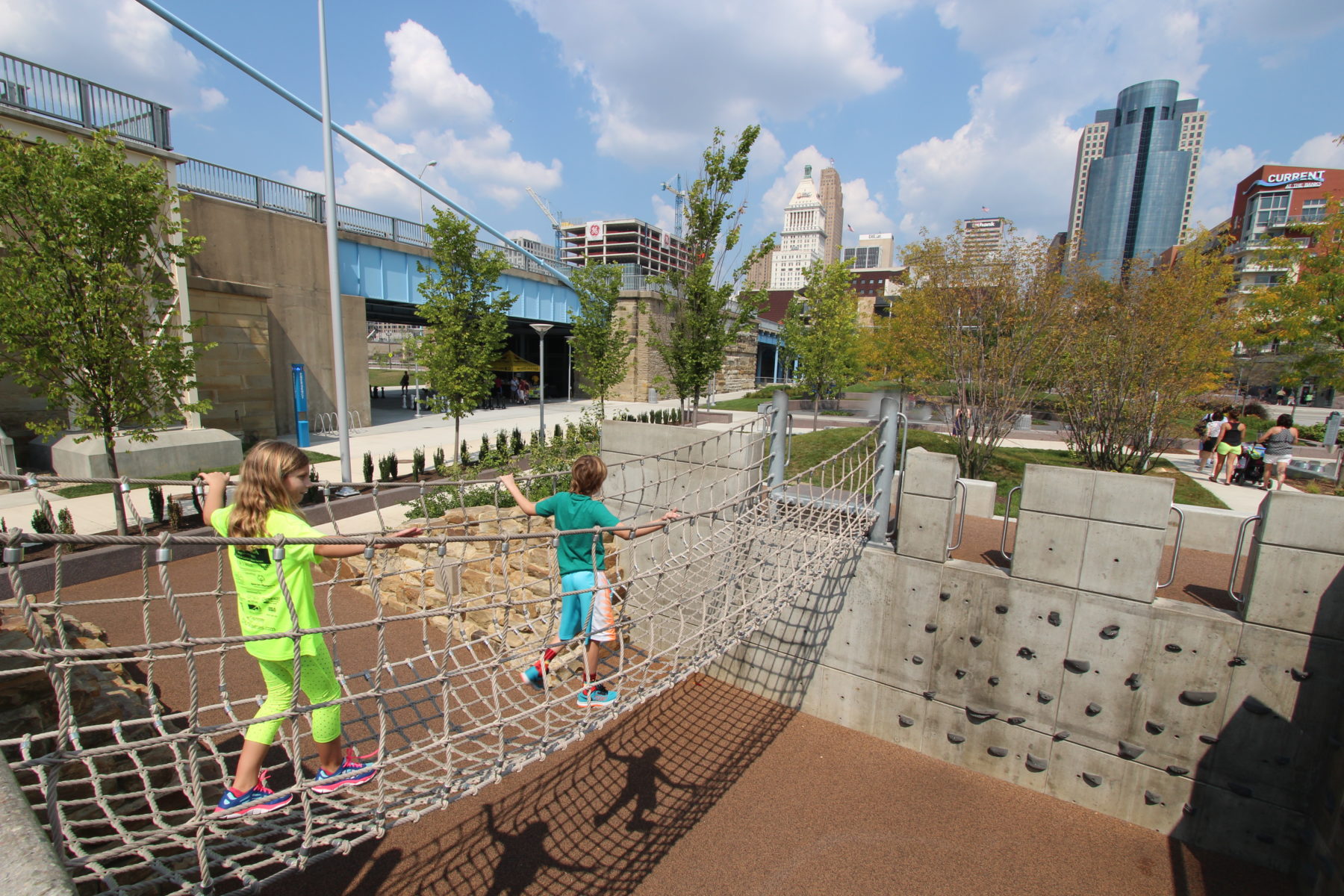 Two children walking across a rope bridge