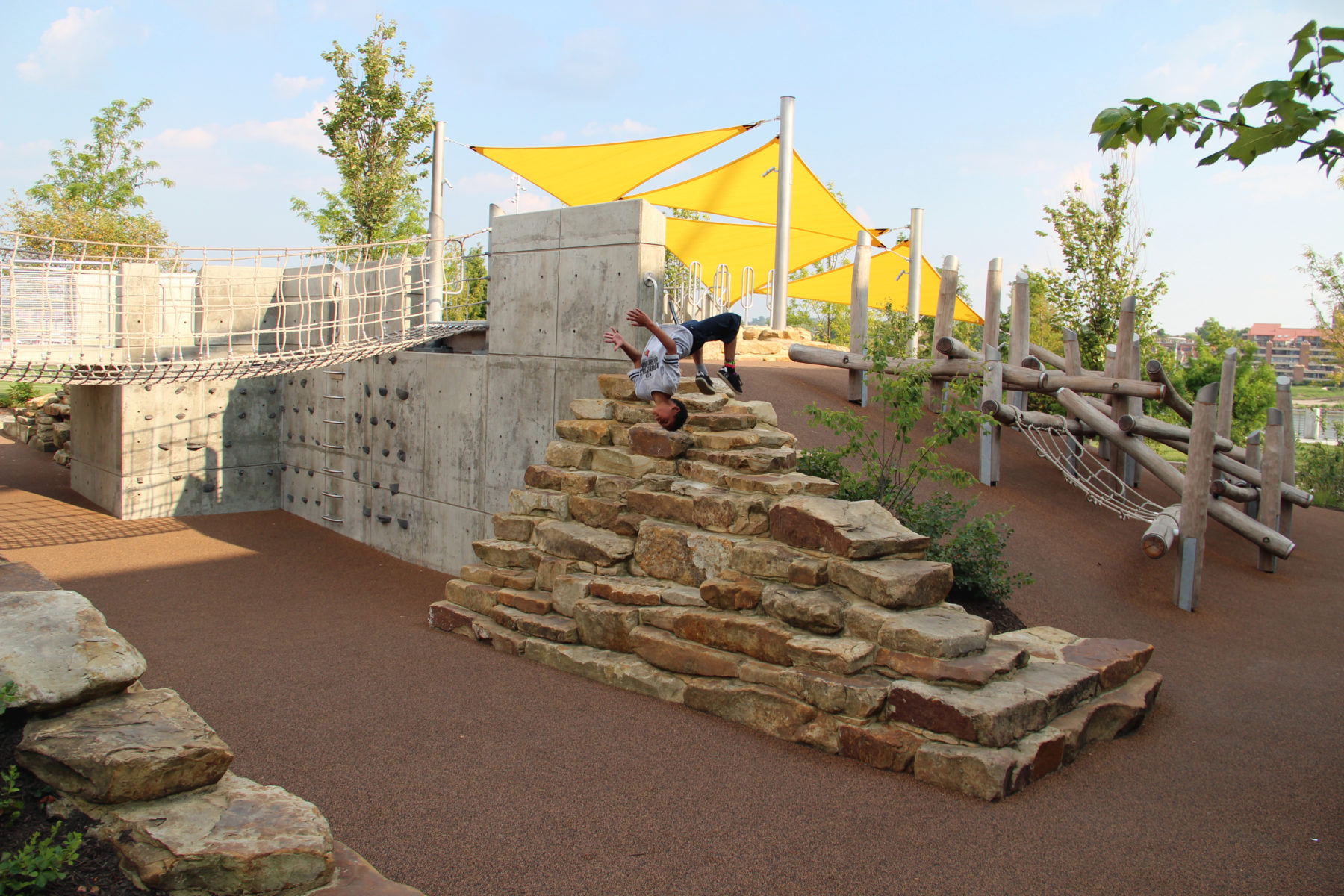 child mid-back flip in climbing area