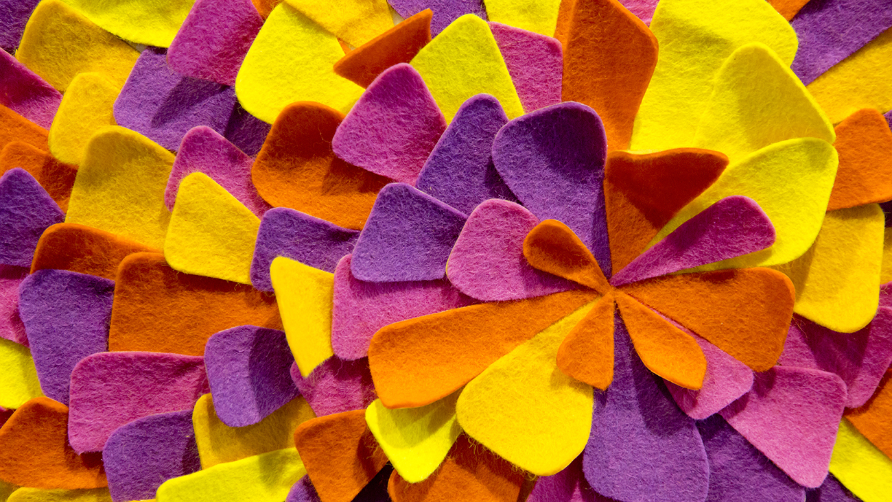 Detail of colorful felt petals on the letter 