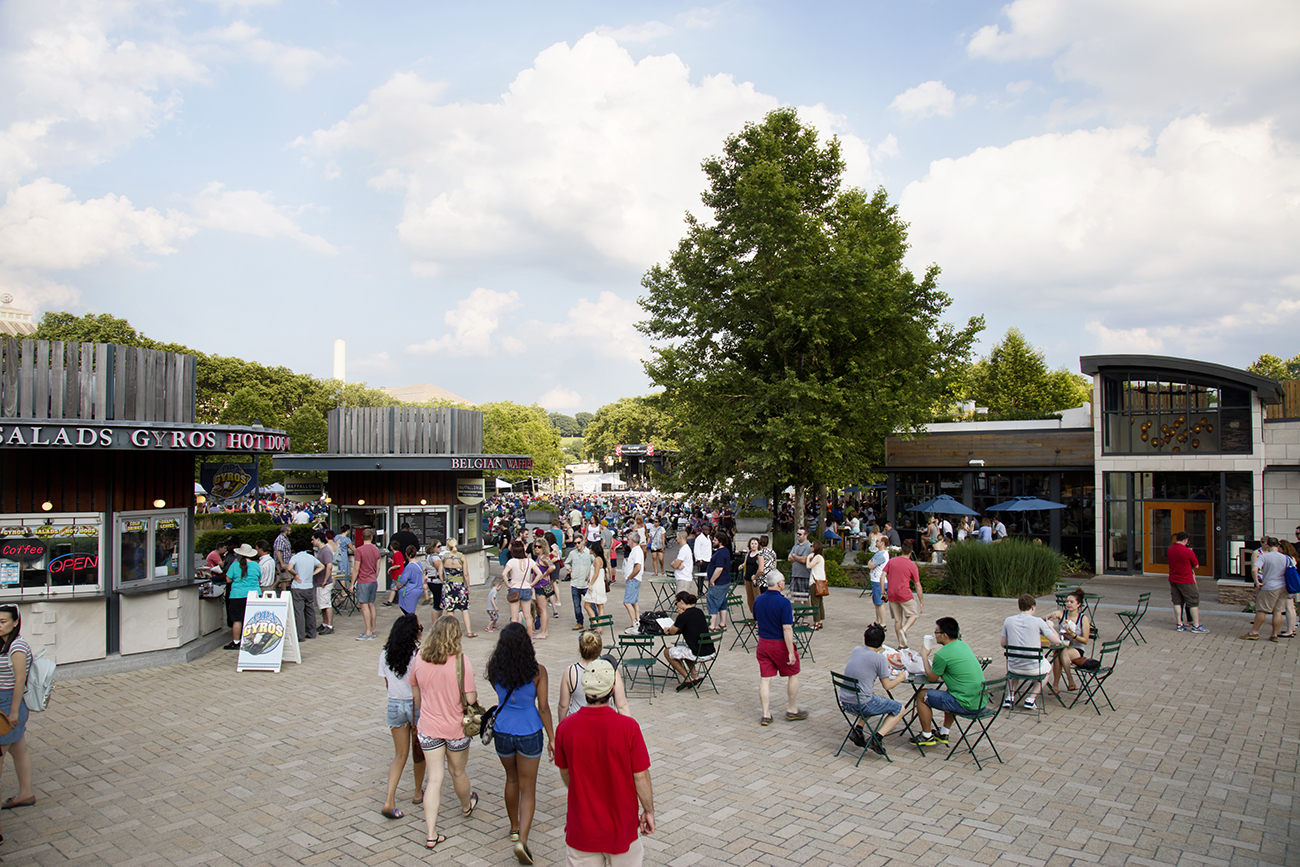 people walking through plaza