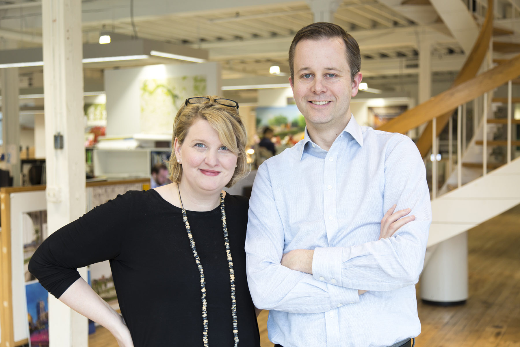 a man and woman posing next to each other