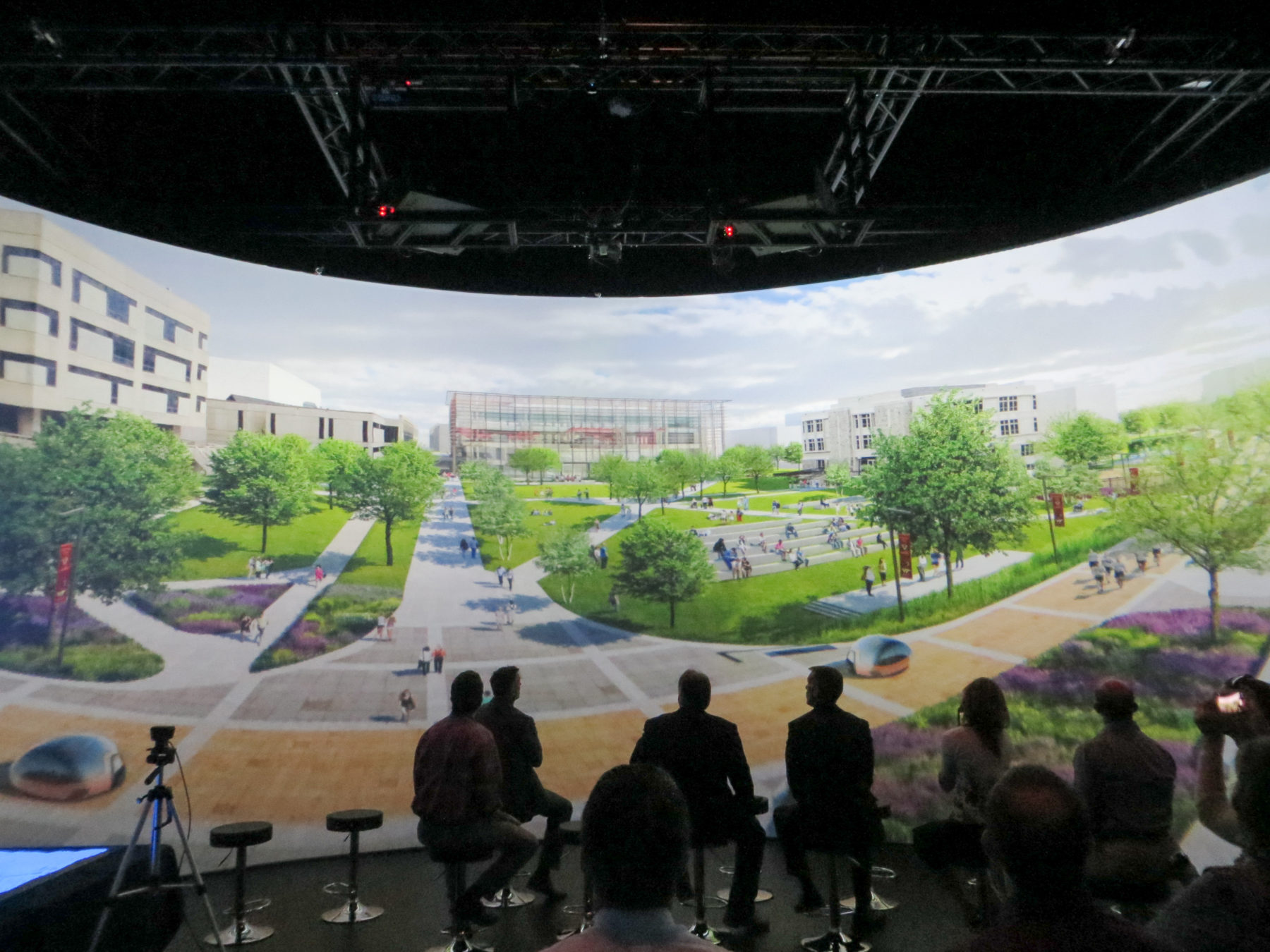 Audience looking at street-level rendering on 360 wraparound screen