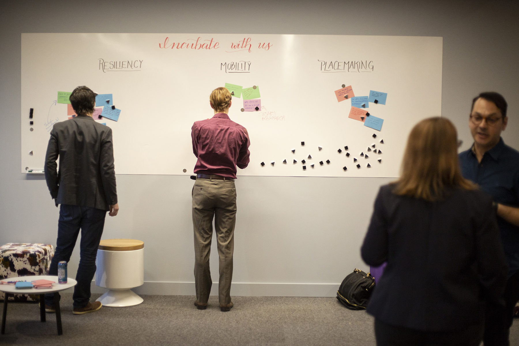 people looking at white board