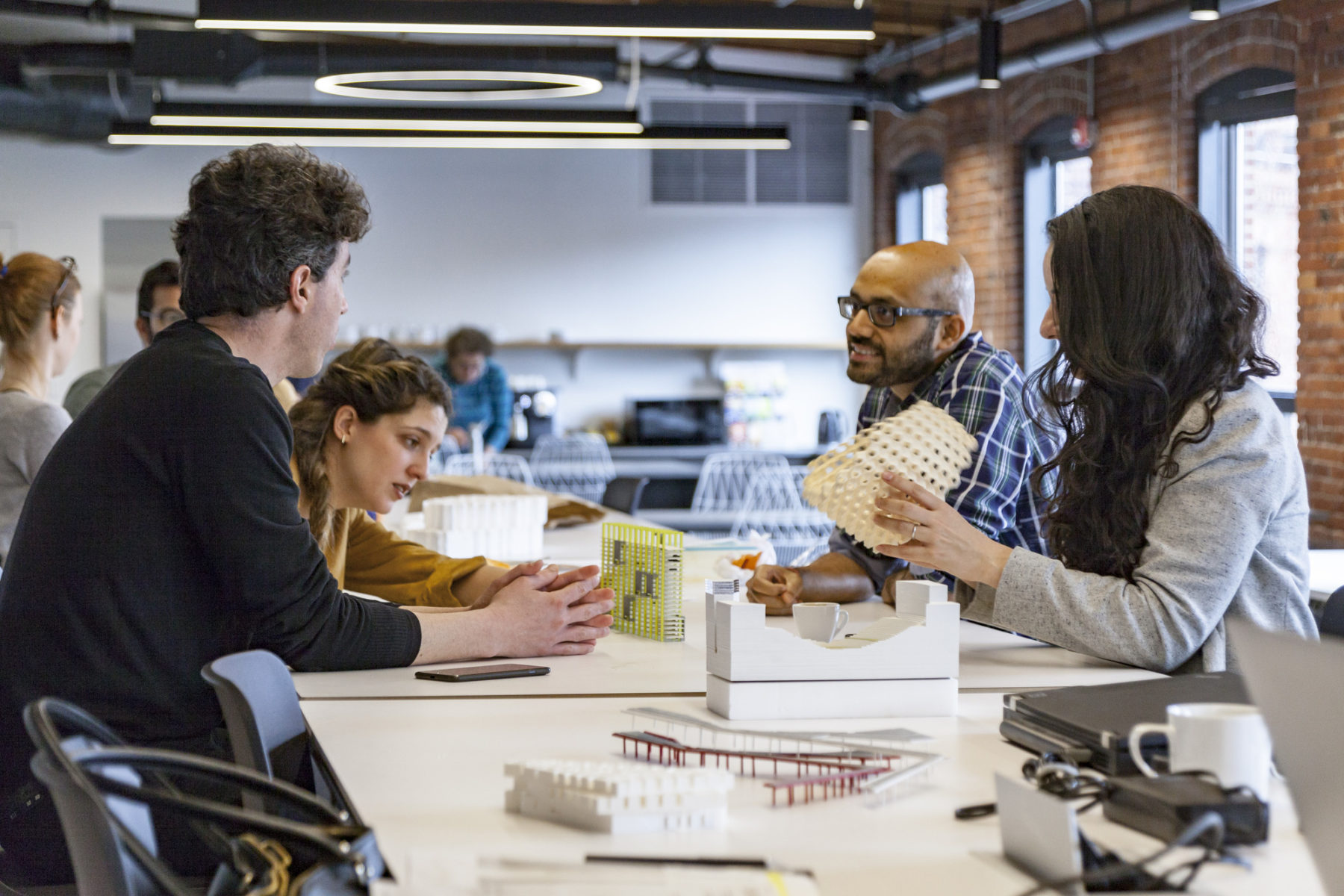 people looking at materials around a table