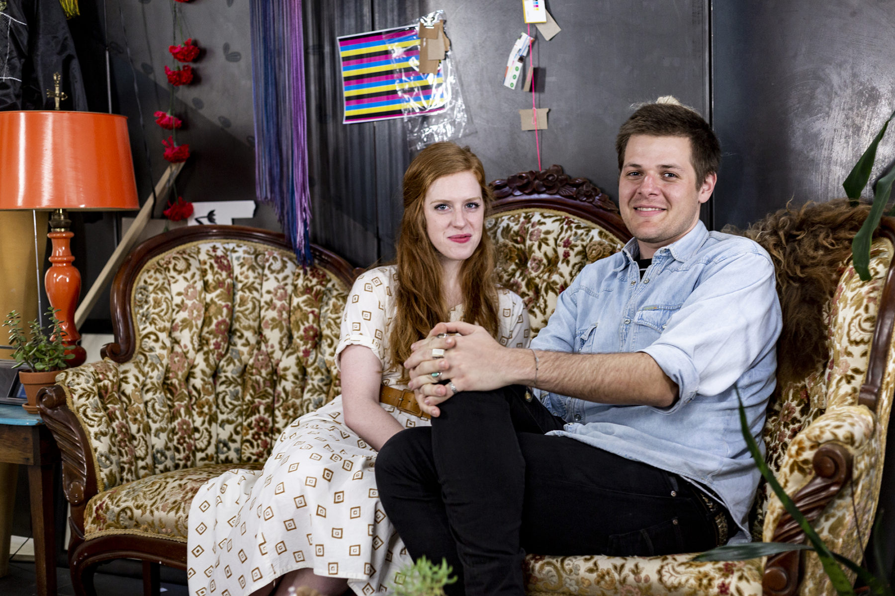 two people sitting on couch