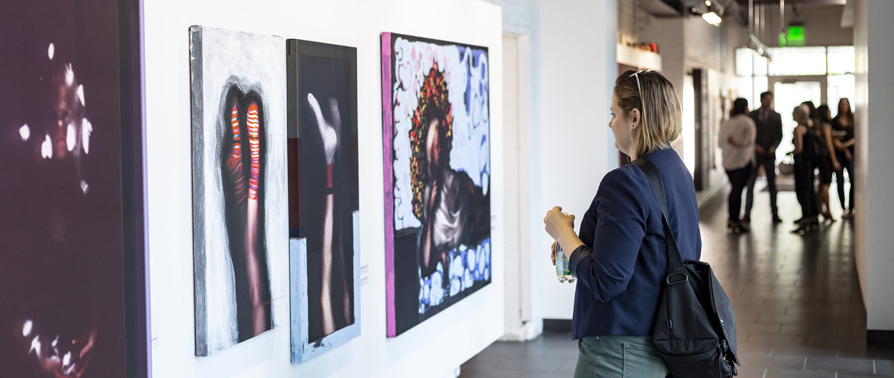 person looking at art on wall