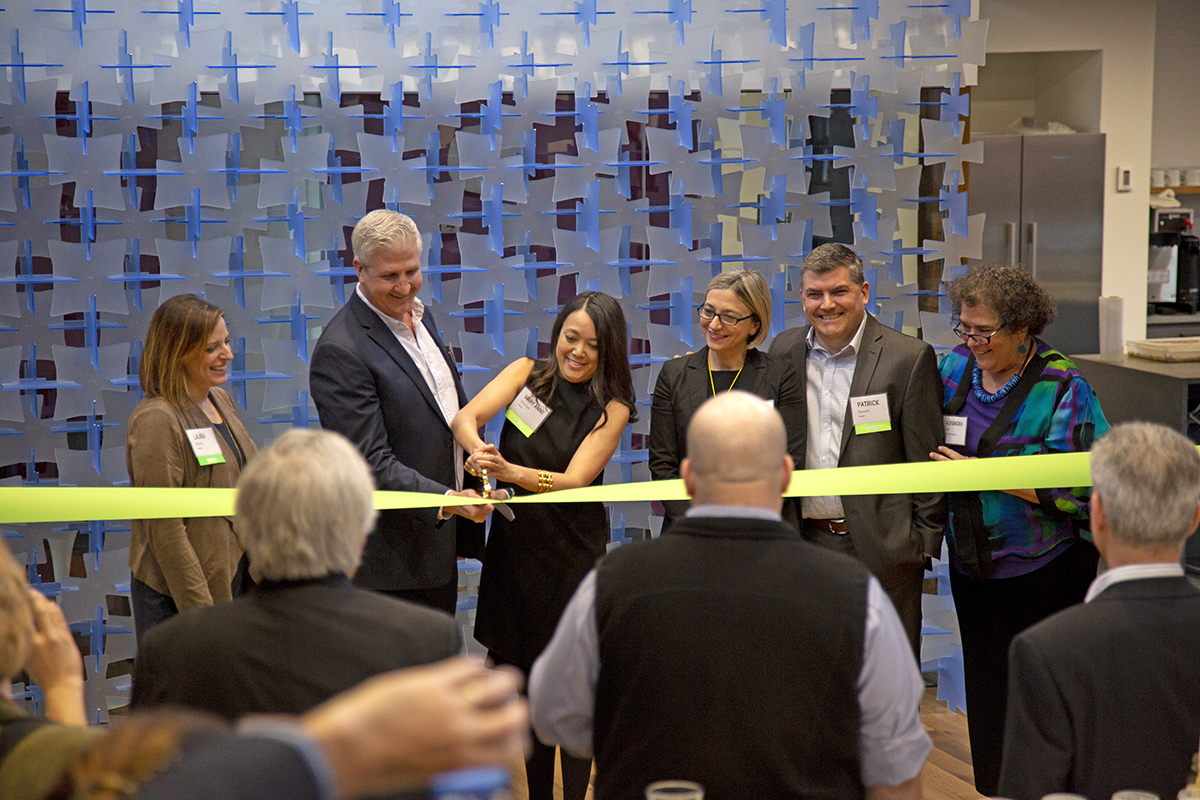 people cutting ribbon