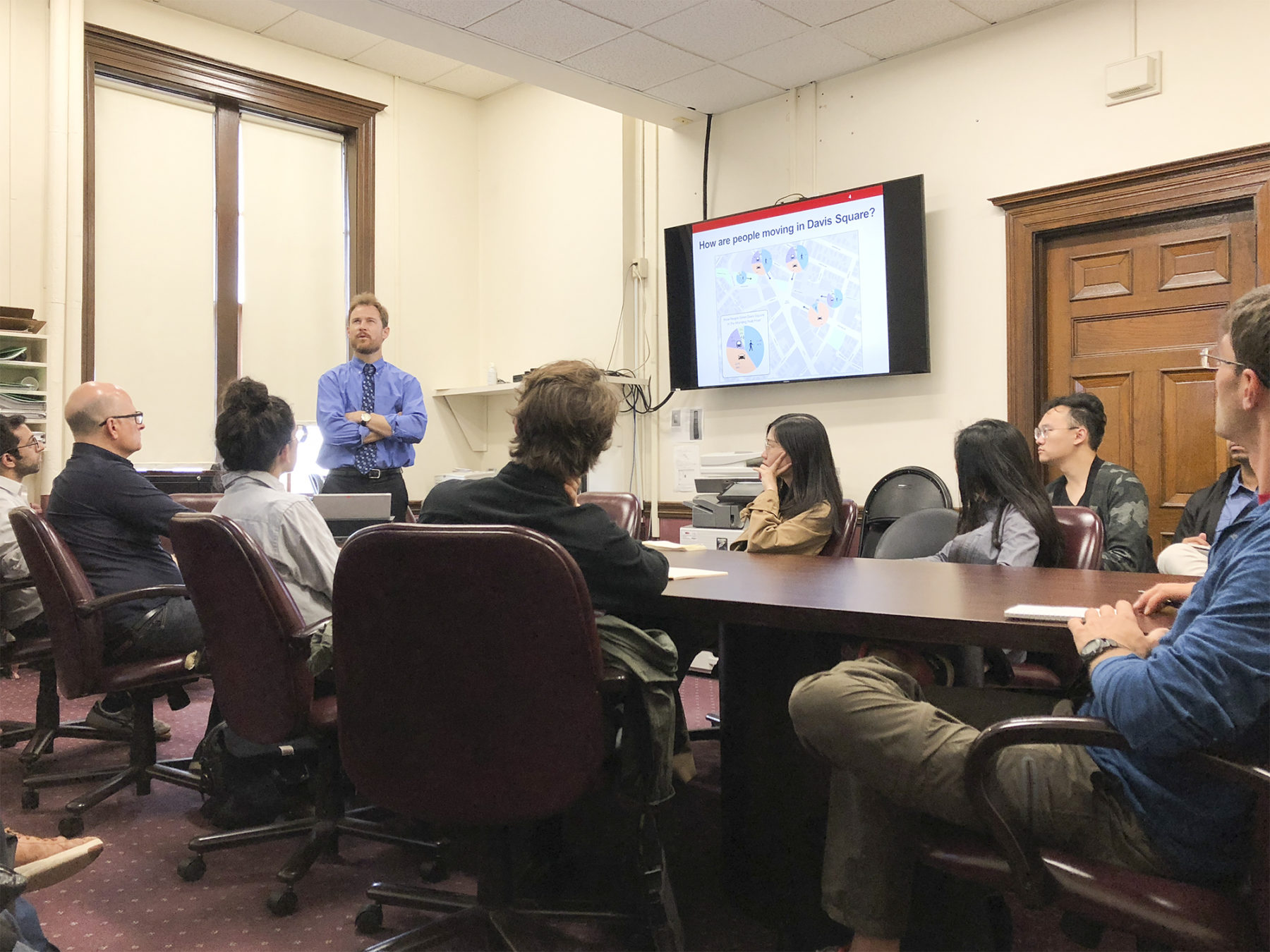 Photo of people sitting around a conference table