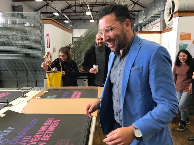 man smiling in print studio