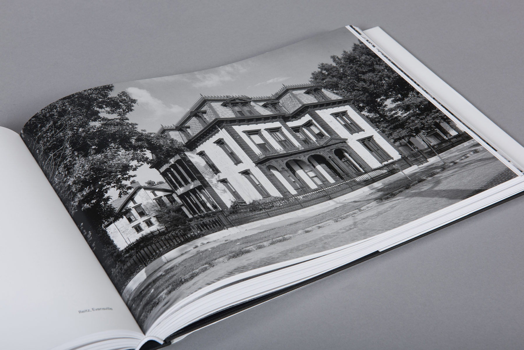 Open page of the book with a photo of the exterior of a historic home in Indiana