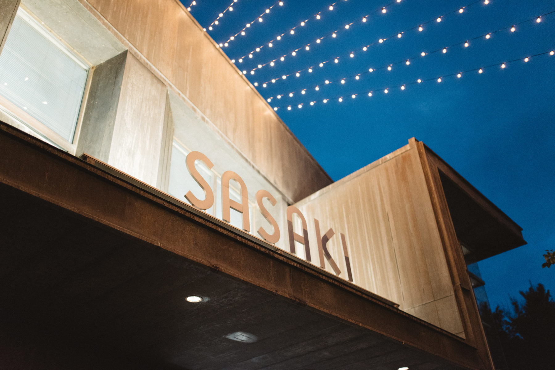 Sasaki logo in front of building illuminated