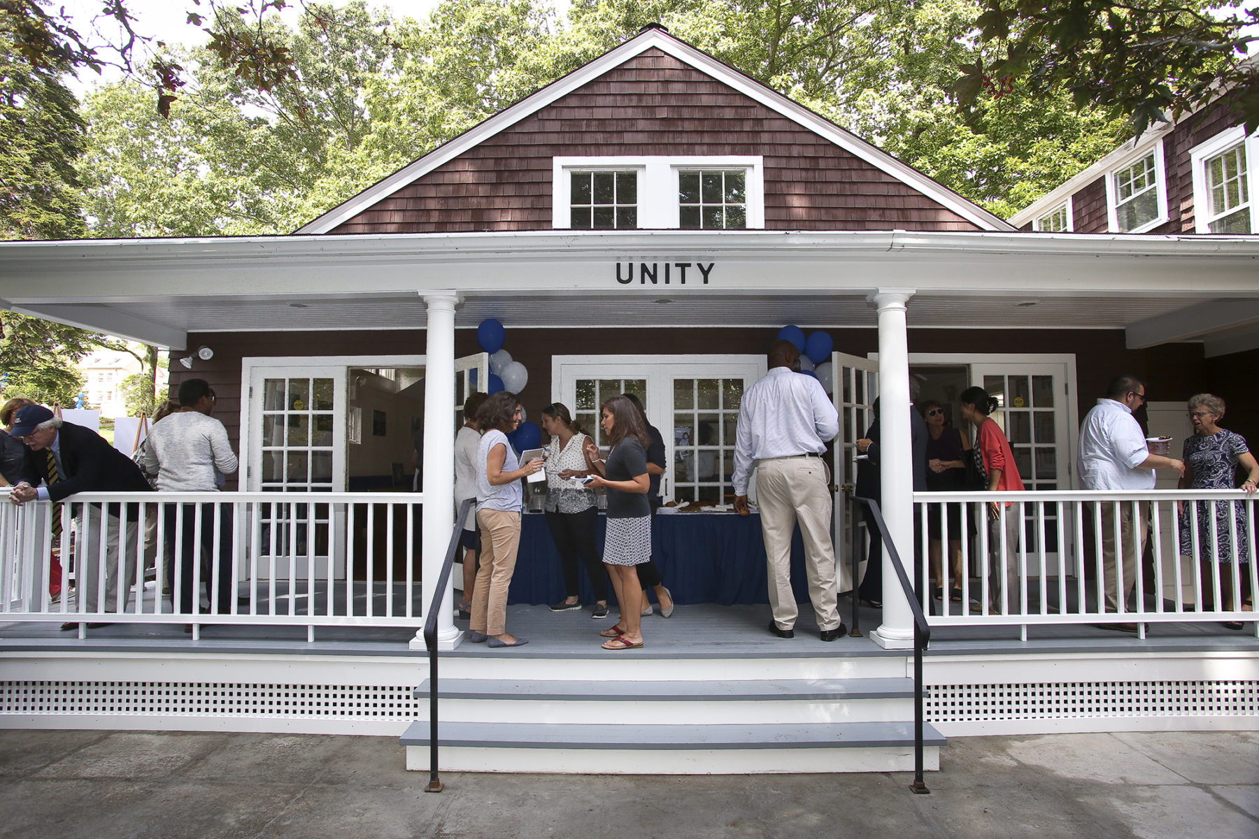 photo of people on the porch of a small building