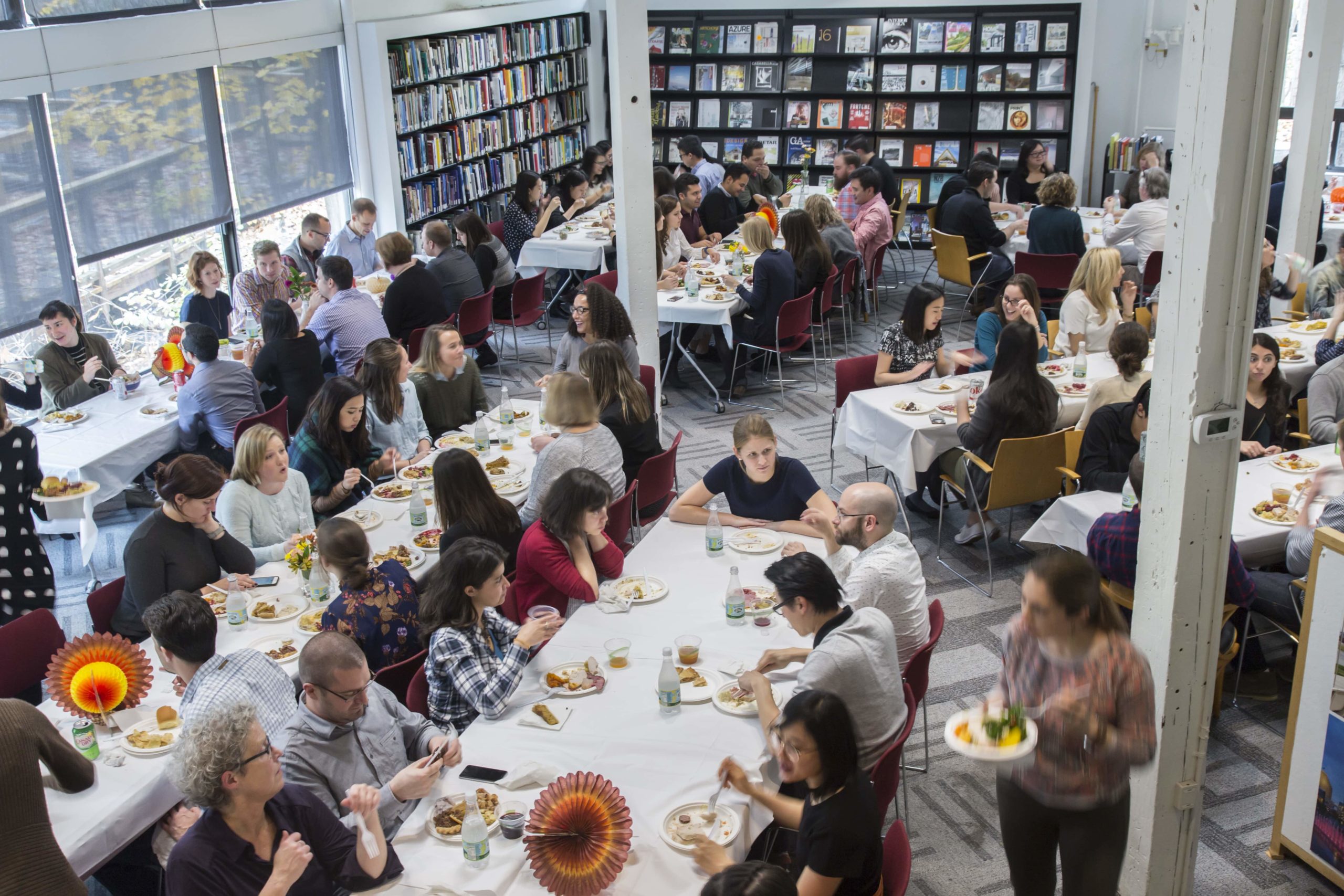 Sasakians sitting at long tables enjoying a Thanksgiving meal