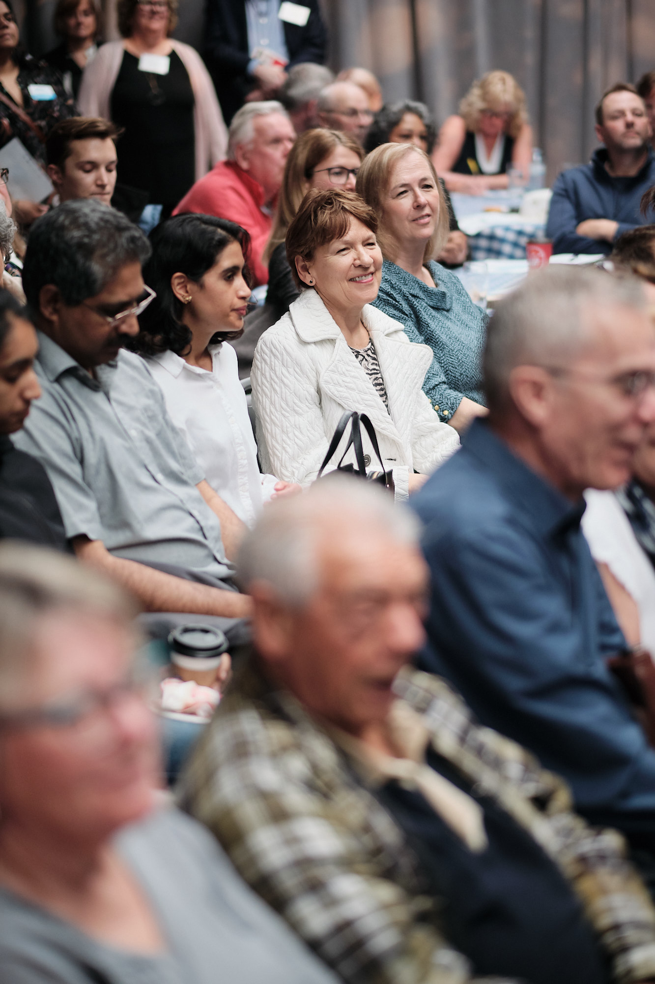 Audience listens intently to presentation at public meeting