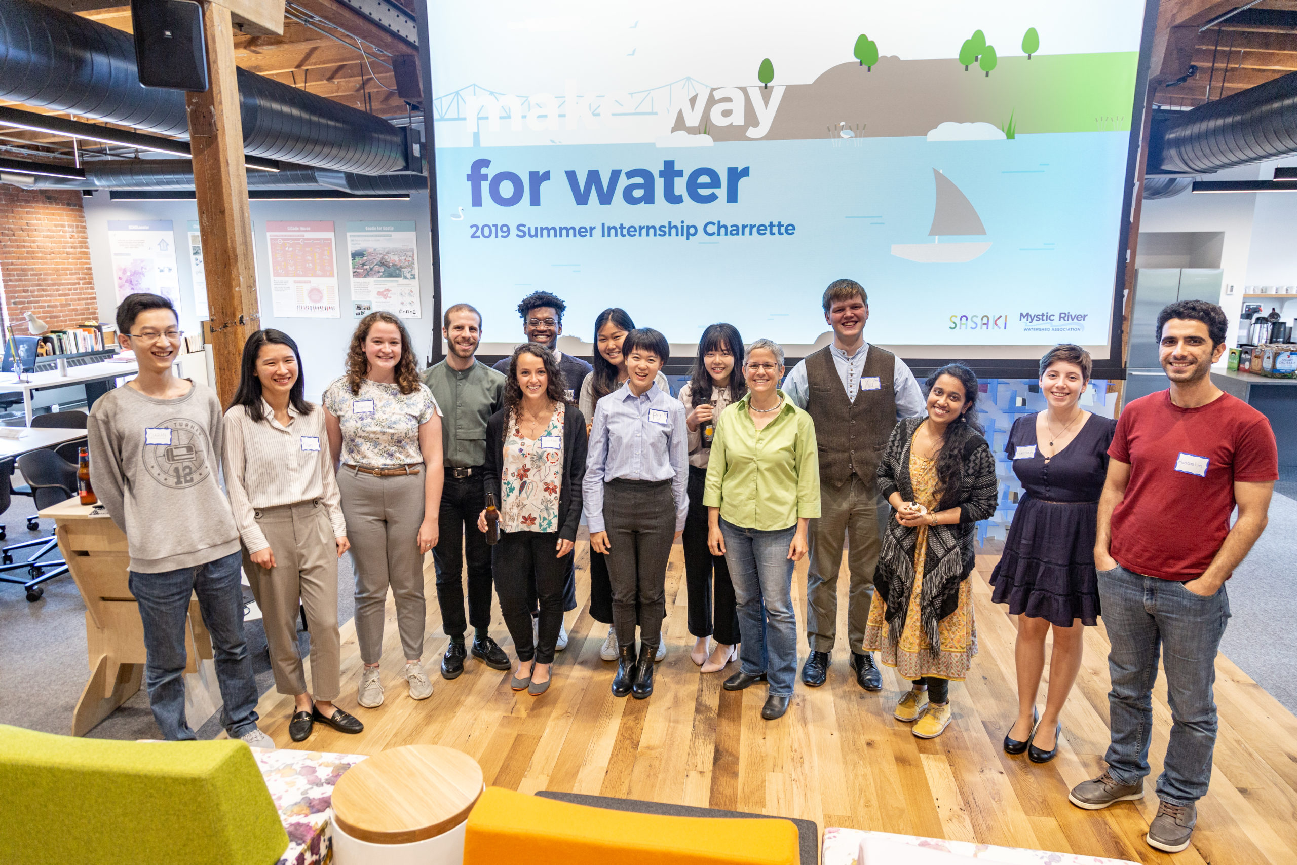 group photo of interns in front of their presentation, 
