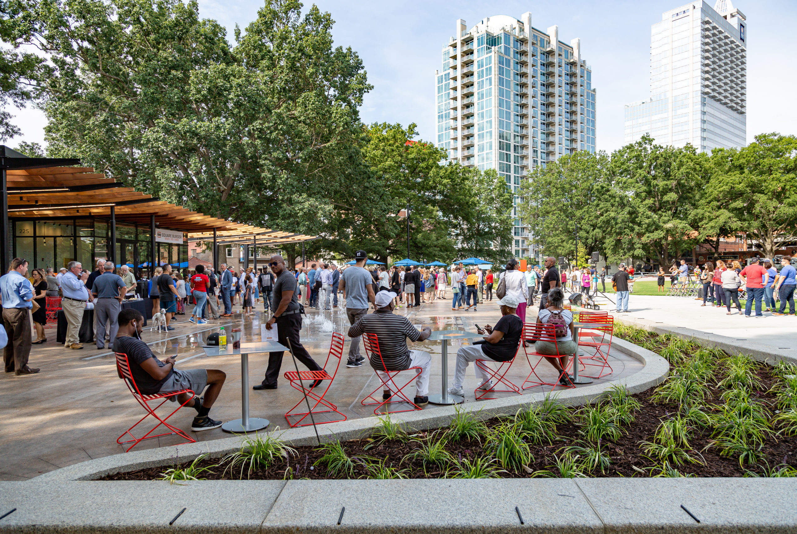 People gathered at tables in park