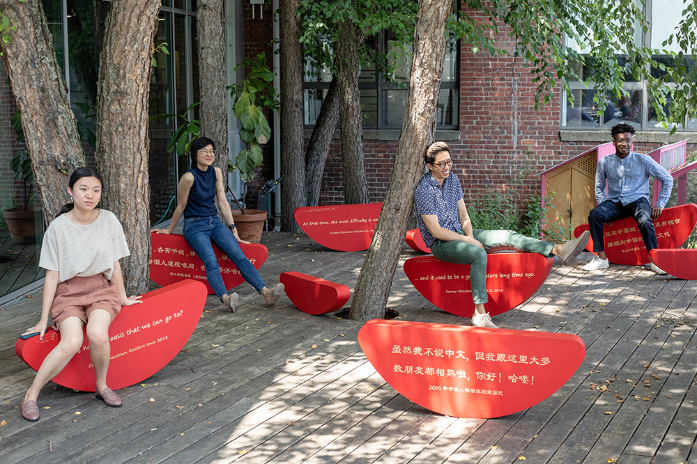 People sit on benches on a patio