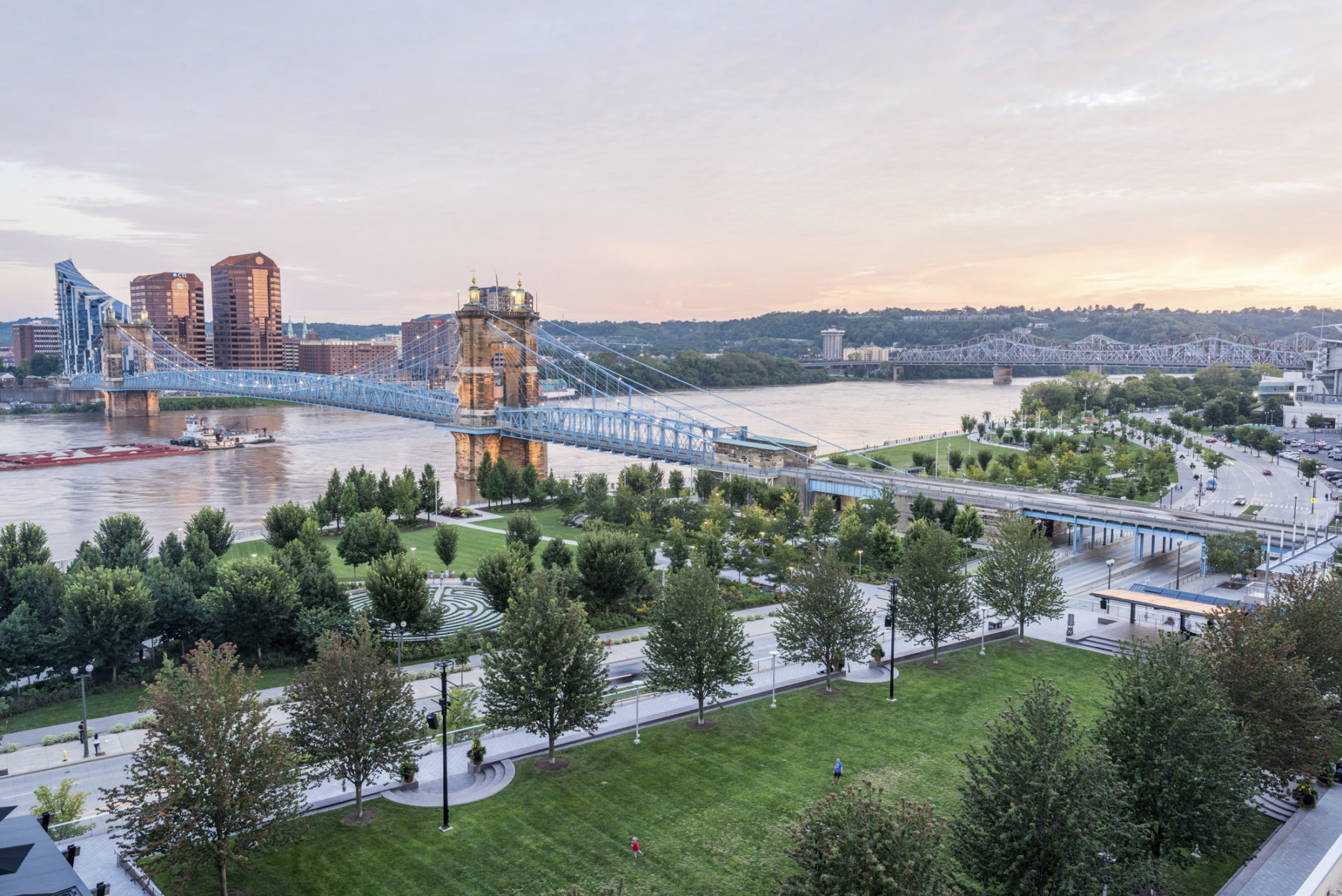 Photo: Bridge spans across Ohio River. A lush park sits in the foreground.