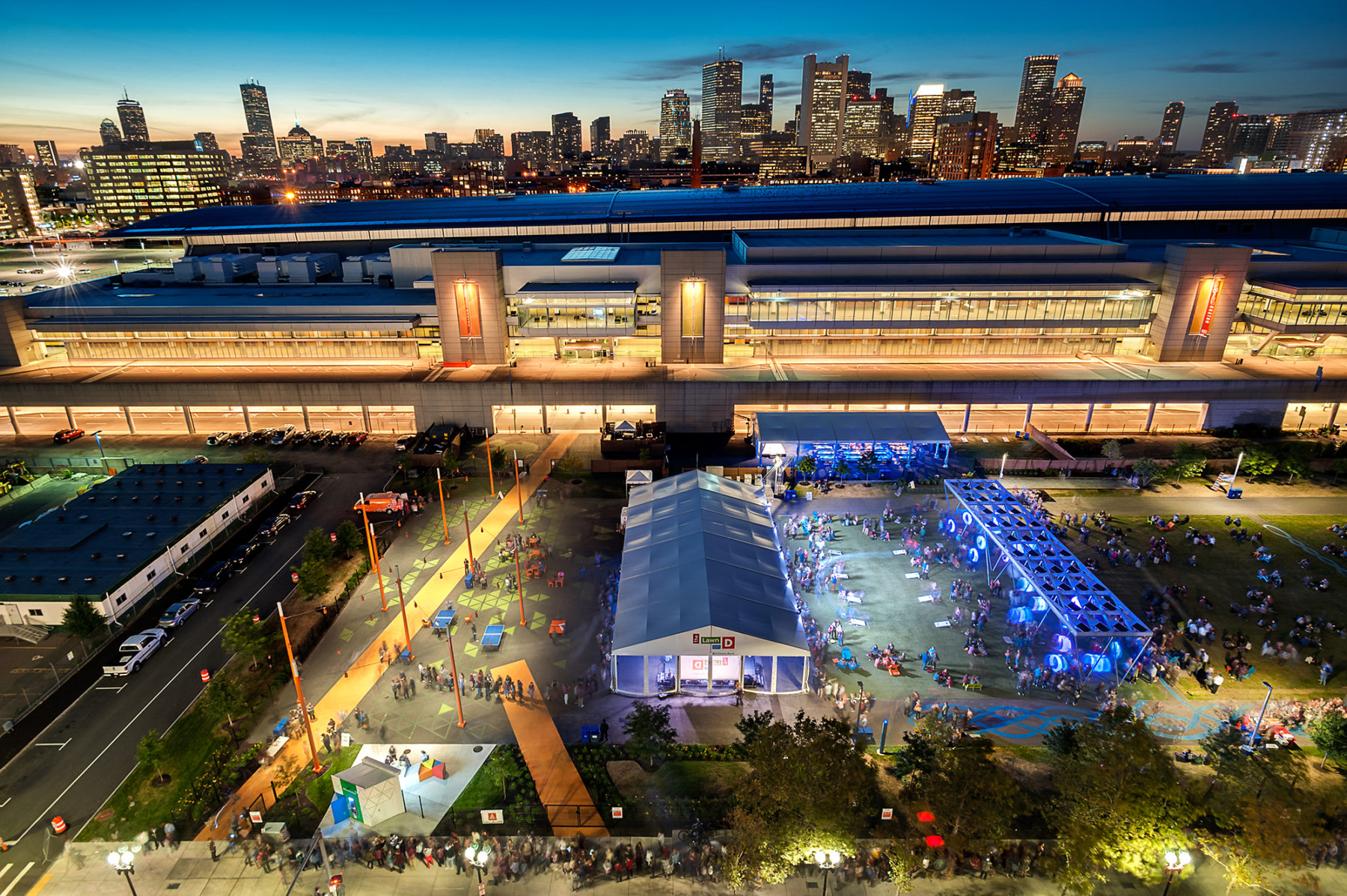 Night photo of looking at the Lawn on D and the convention center back to downtown Boston