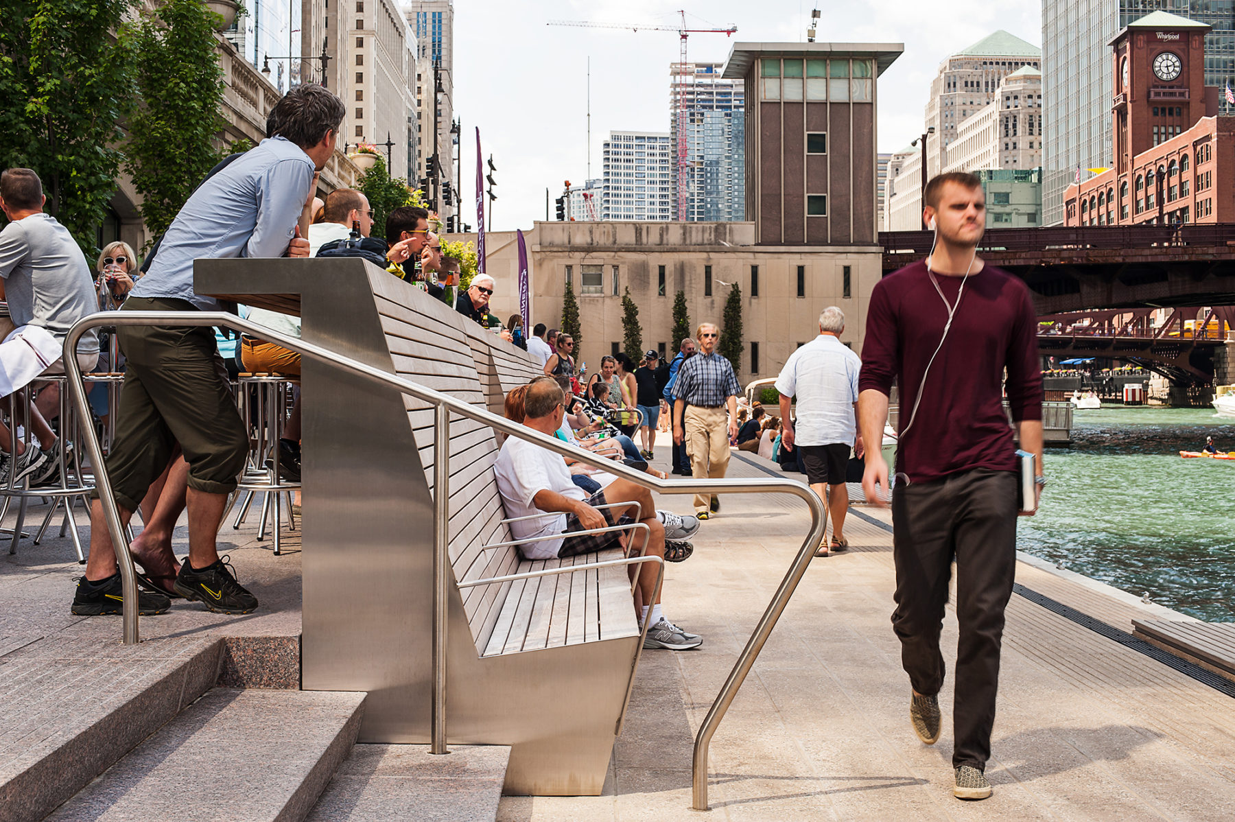 people walking along riverwalk