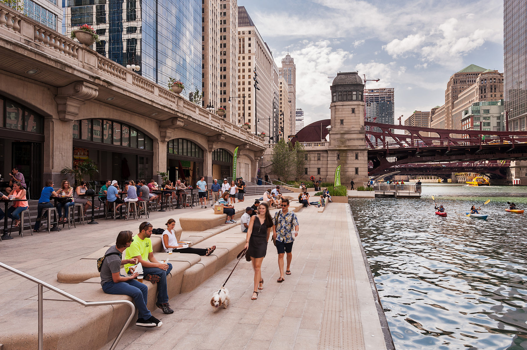 people walking along riverway