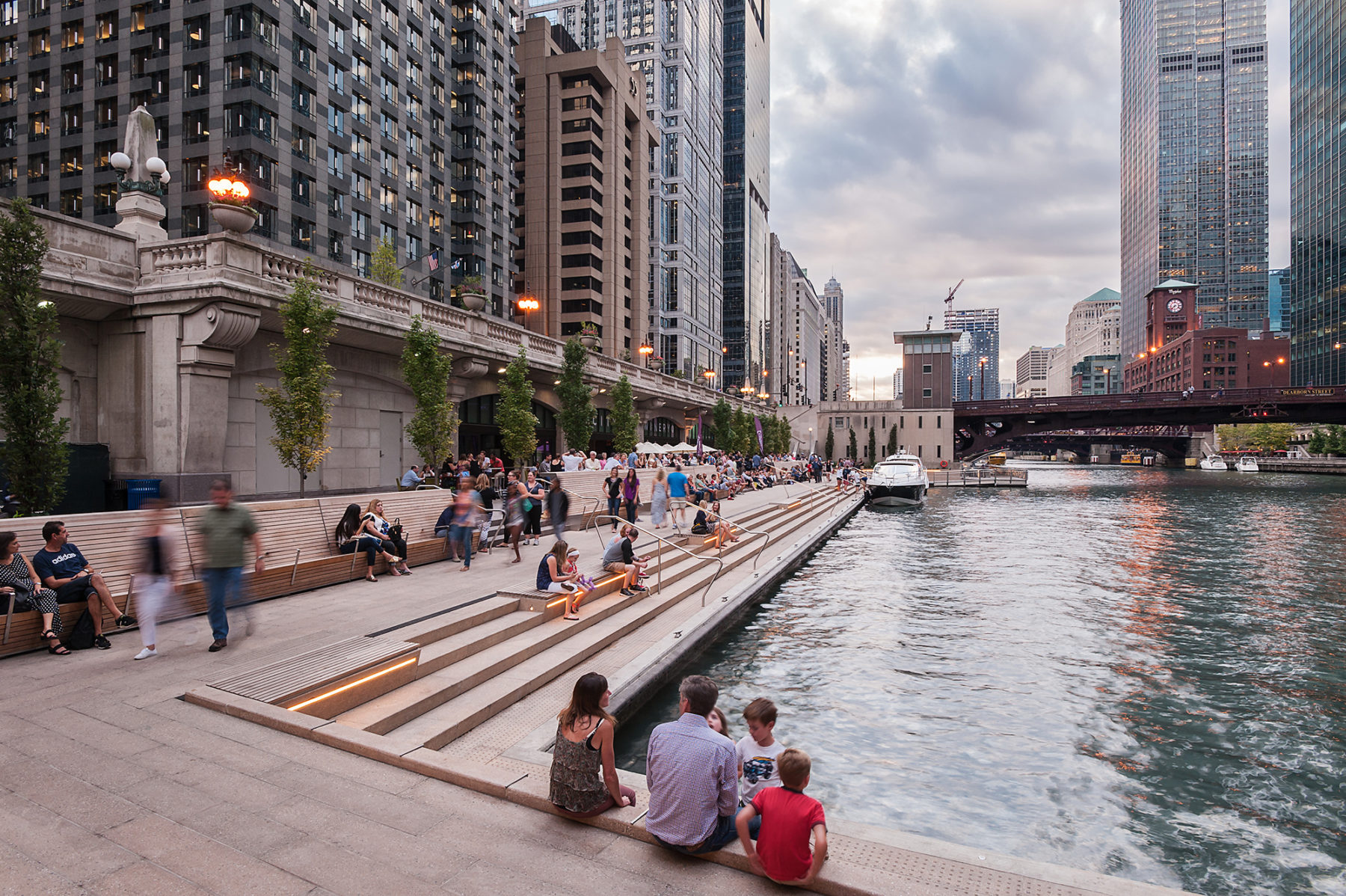 stairs and people sitting at rivers edge