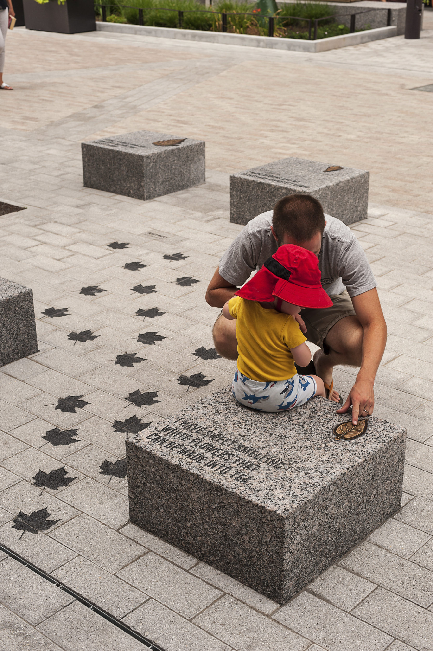 Father playing with daughter along stone path