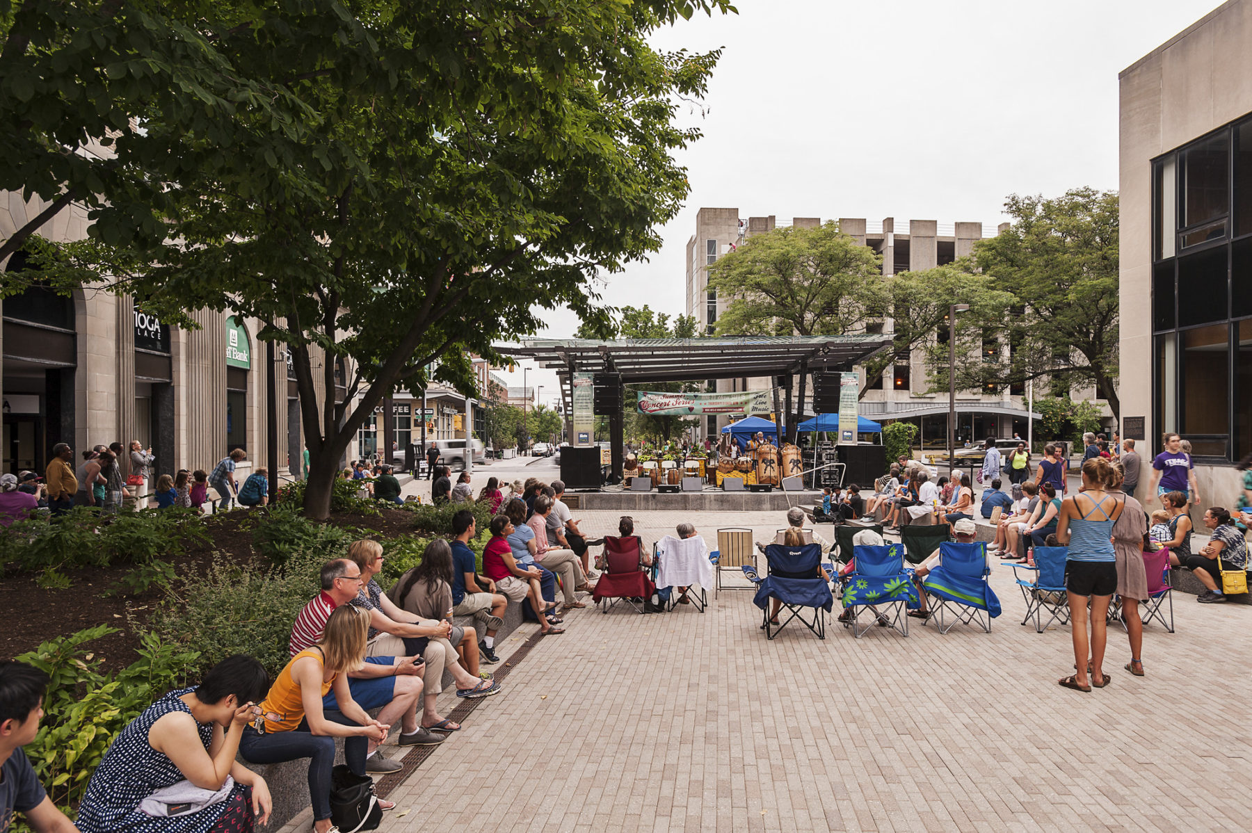 A crowd enjoys live music within the pedestrian mall