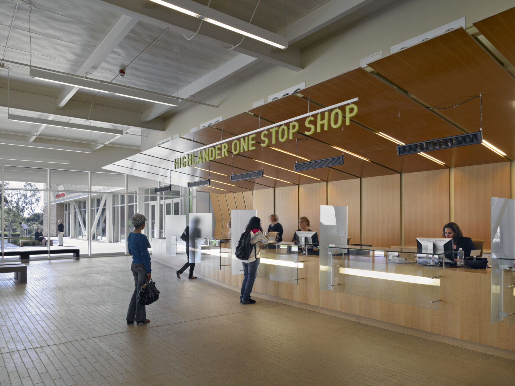 Interior photo of students waiting for support services at the main desk