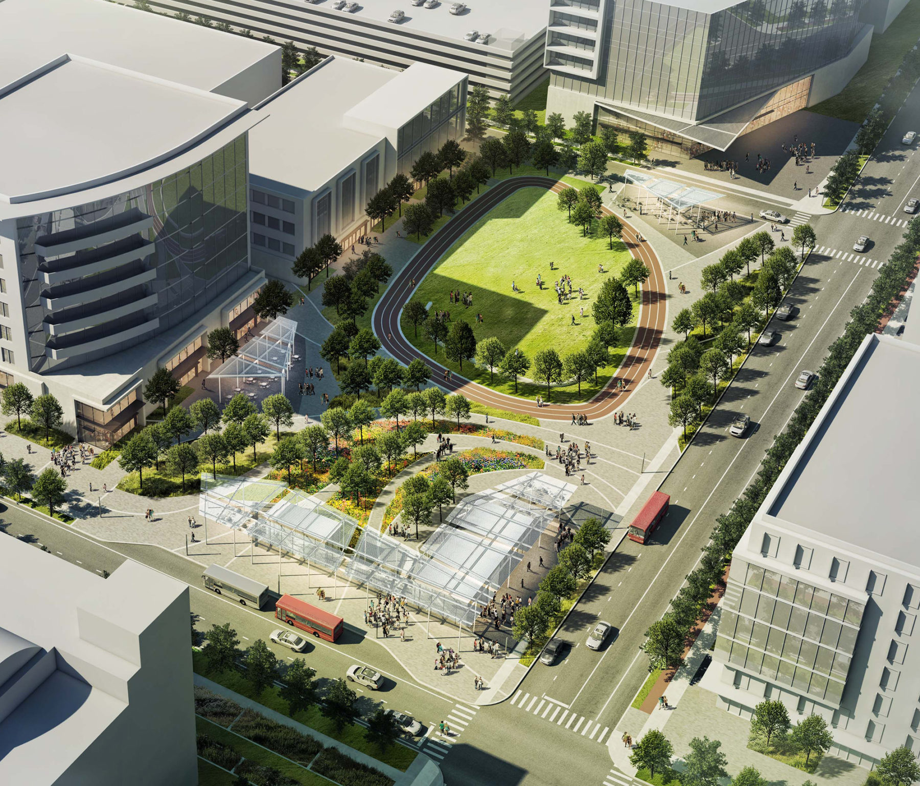 Aerial view of the medical center campus. A large track and park in front of contemporary glass buildings