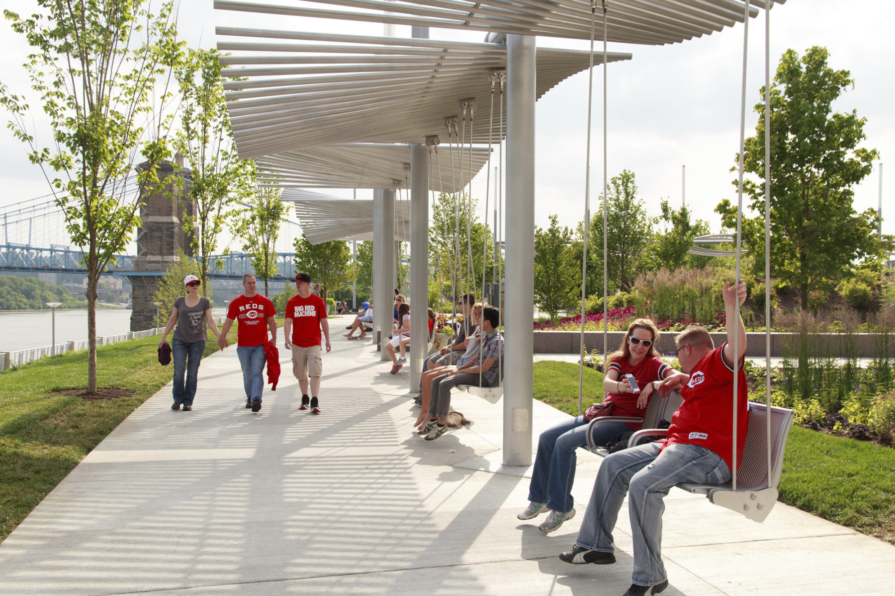 People sitting on swinging benches