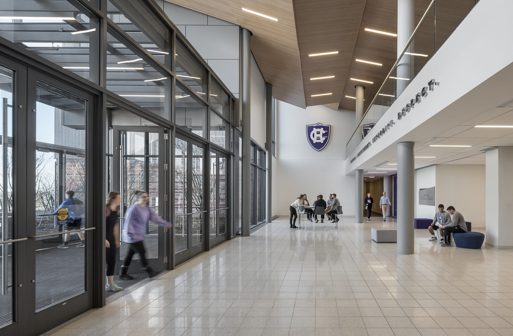 walkway with people coming through glass doors