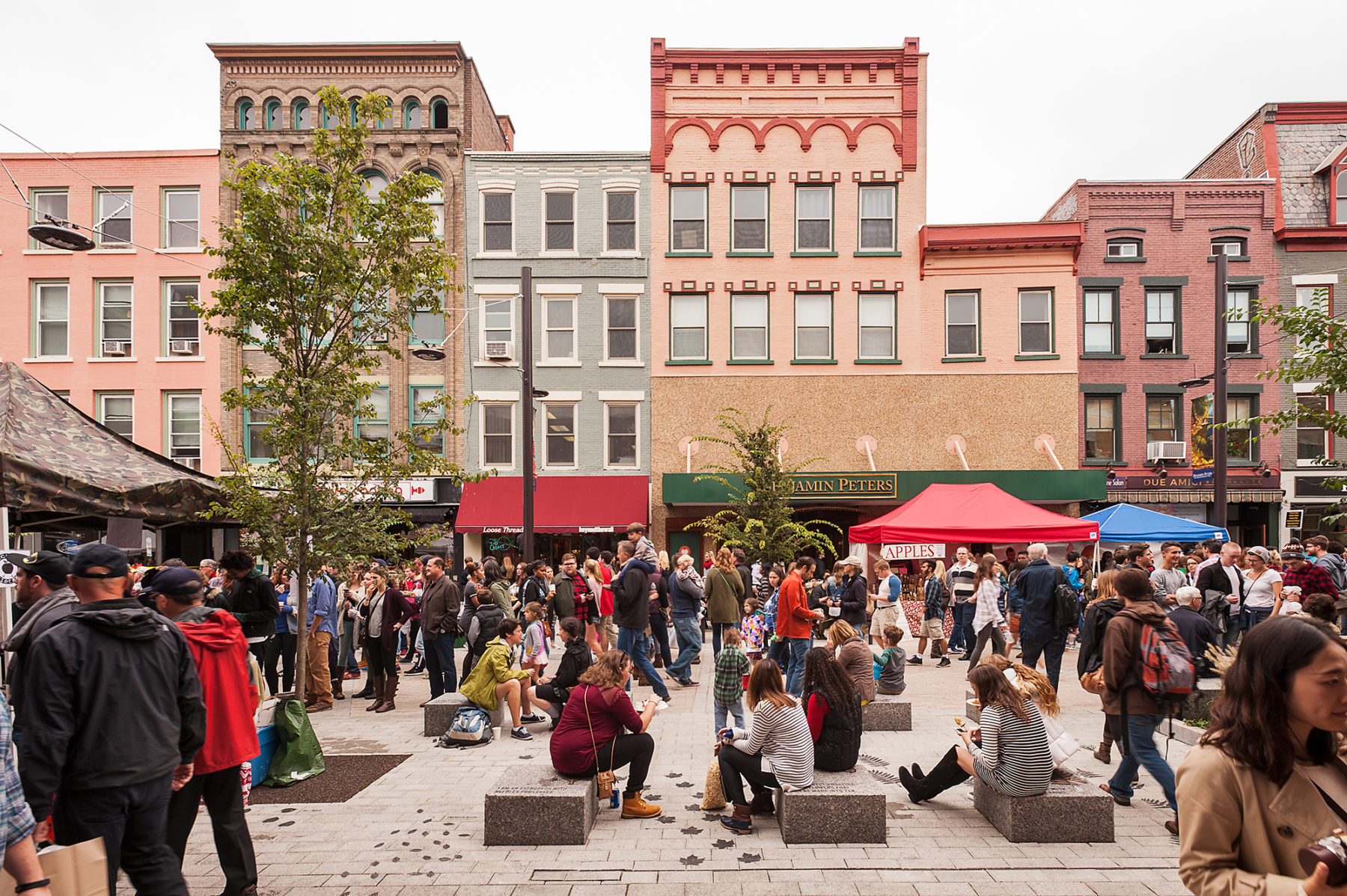 Crowd congregate around the shops along the pedestrian mall