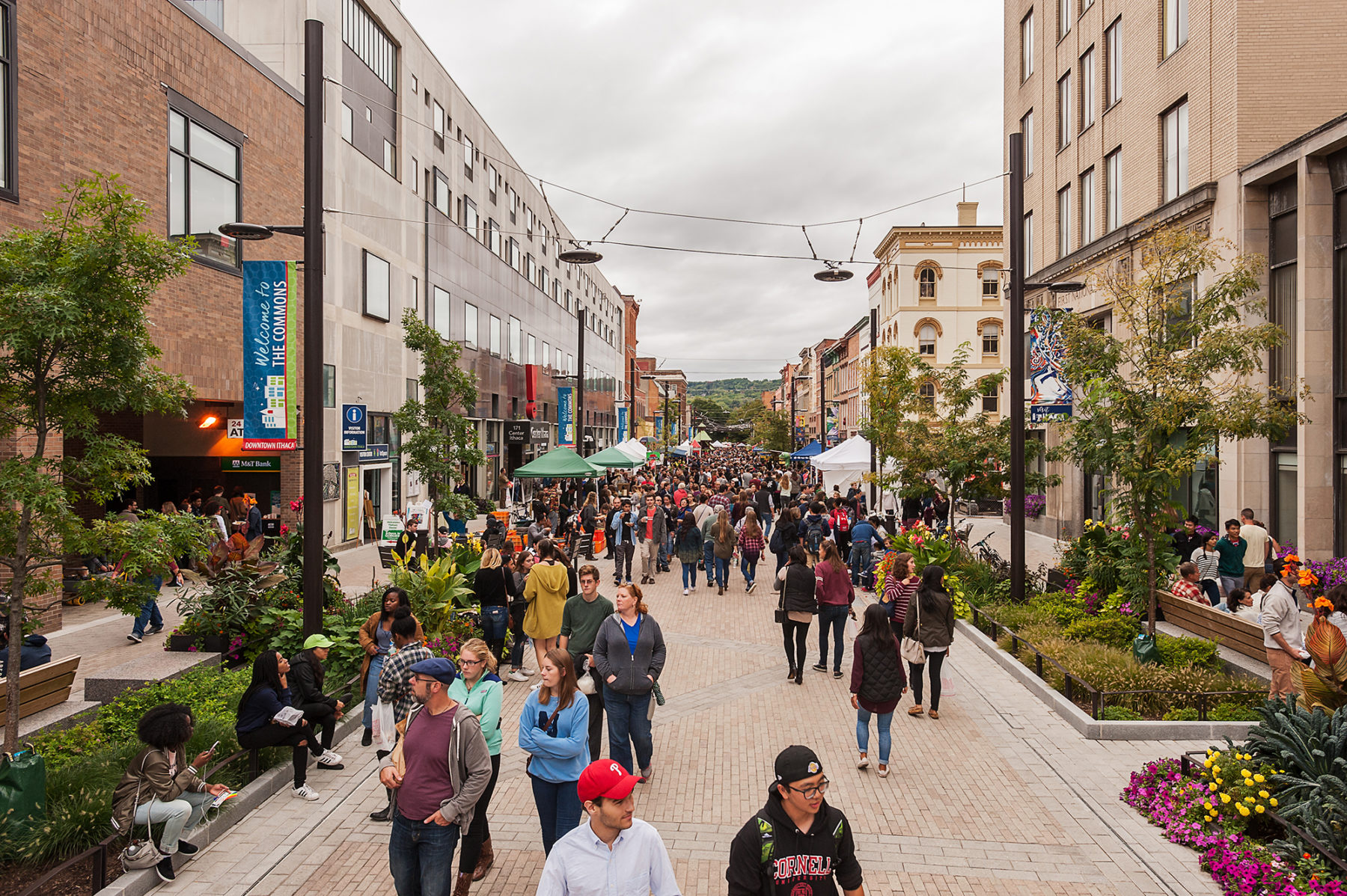 Crowd walks up the main strip of the pedestrian mall