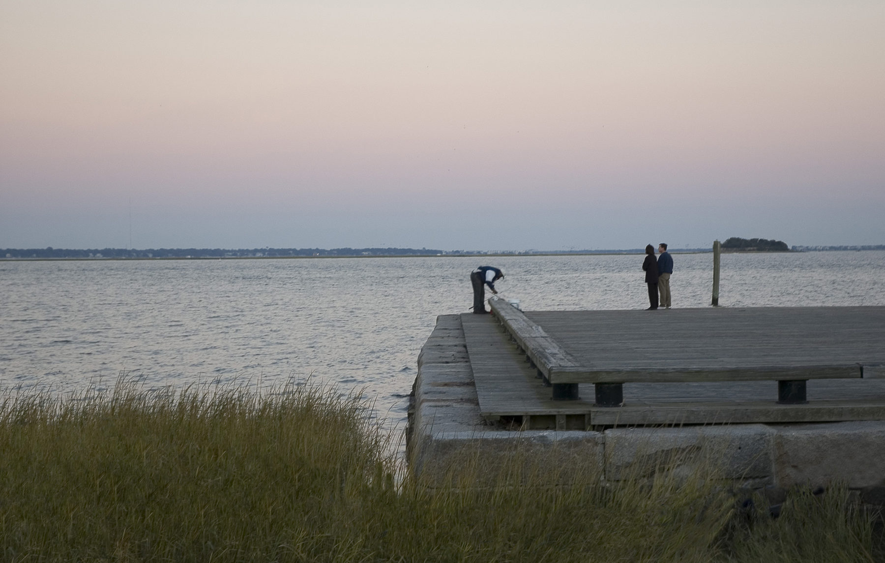 Photo of people on dock at water's edge