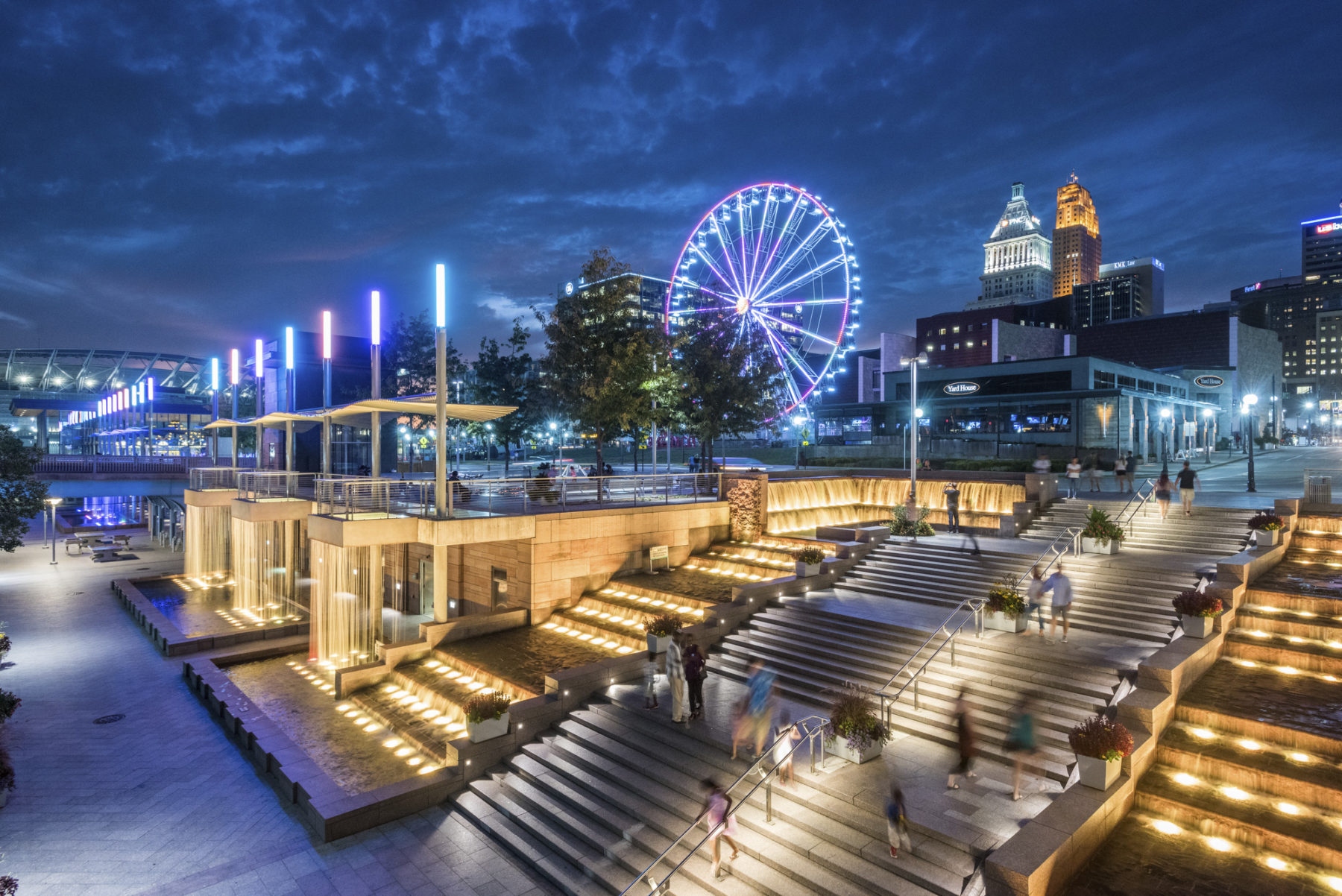 The park is illuminated and there is a glowing ferris wheel in the background.