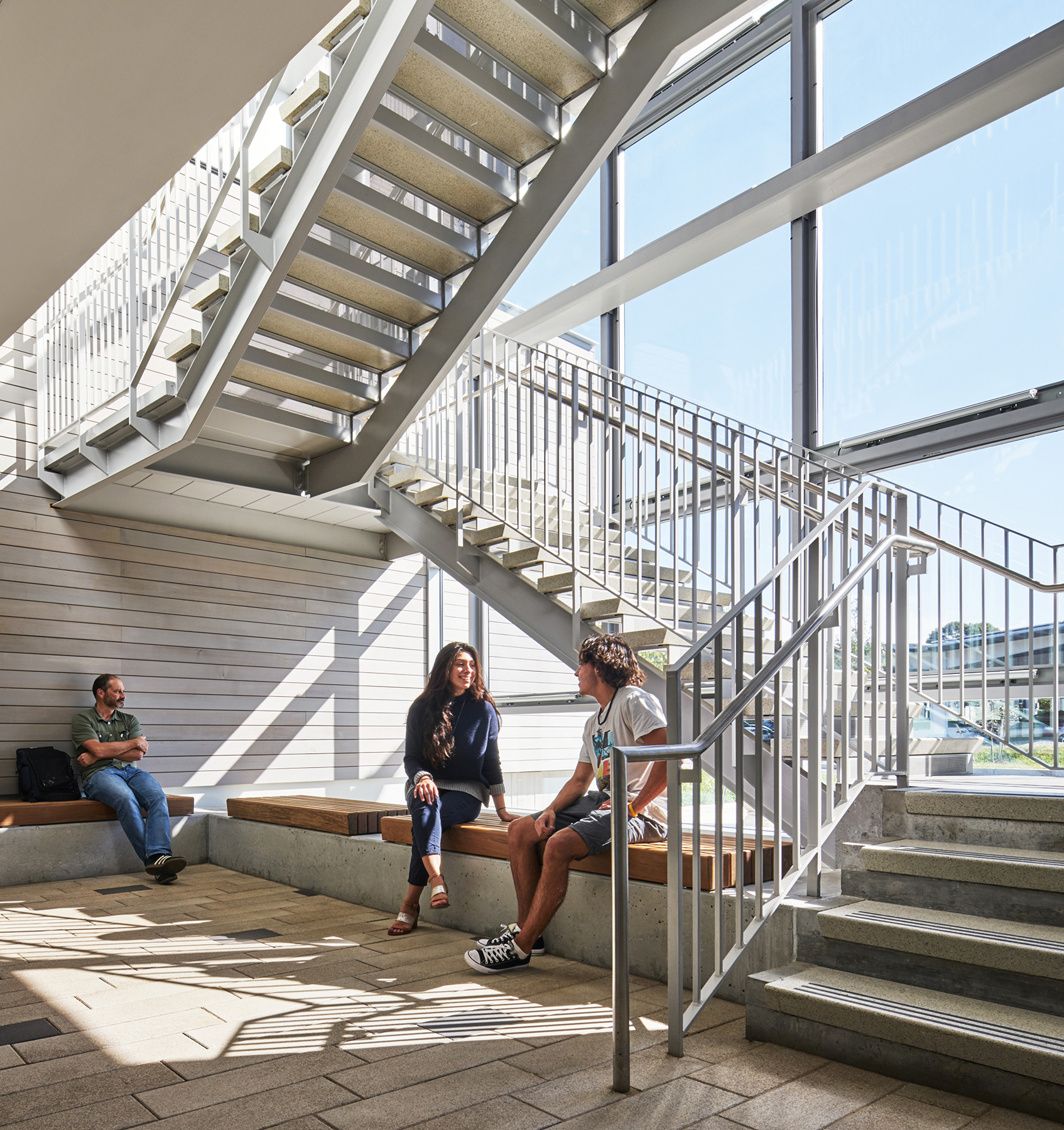 Staircase with people sitting under it