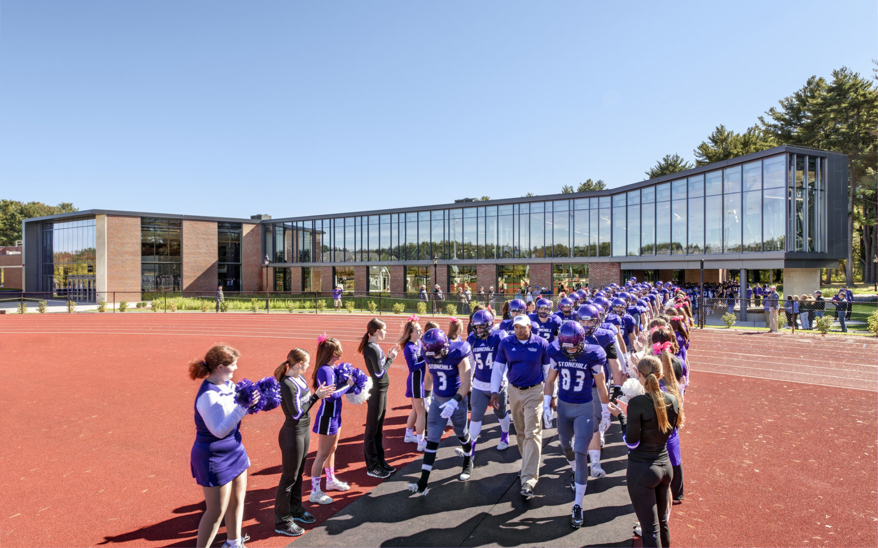 people on a track welcome a team