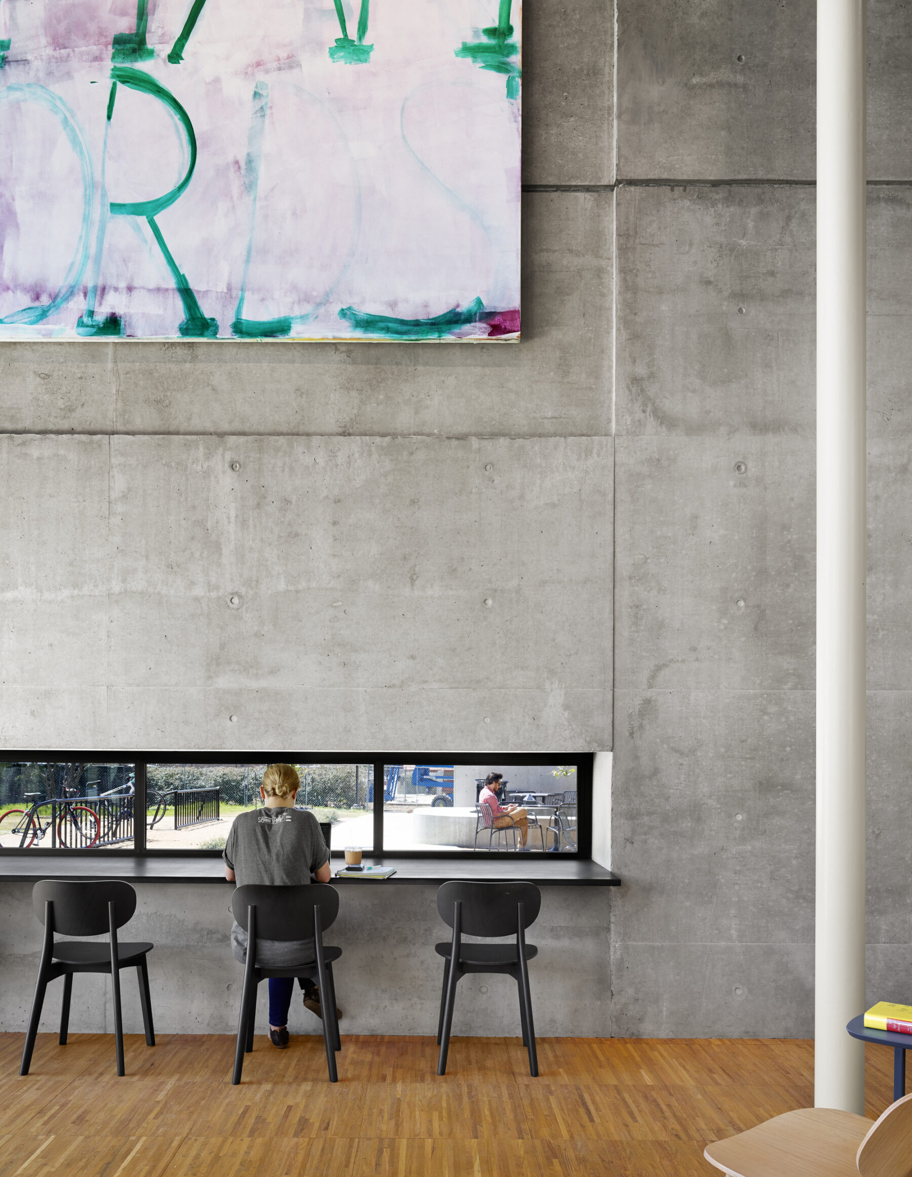 detail photograph of student working at countertop in front of windows