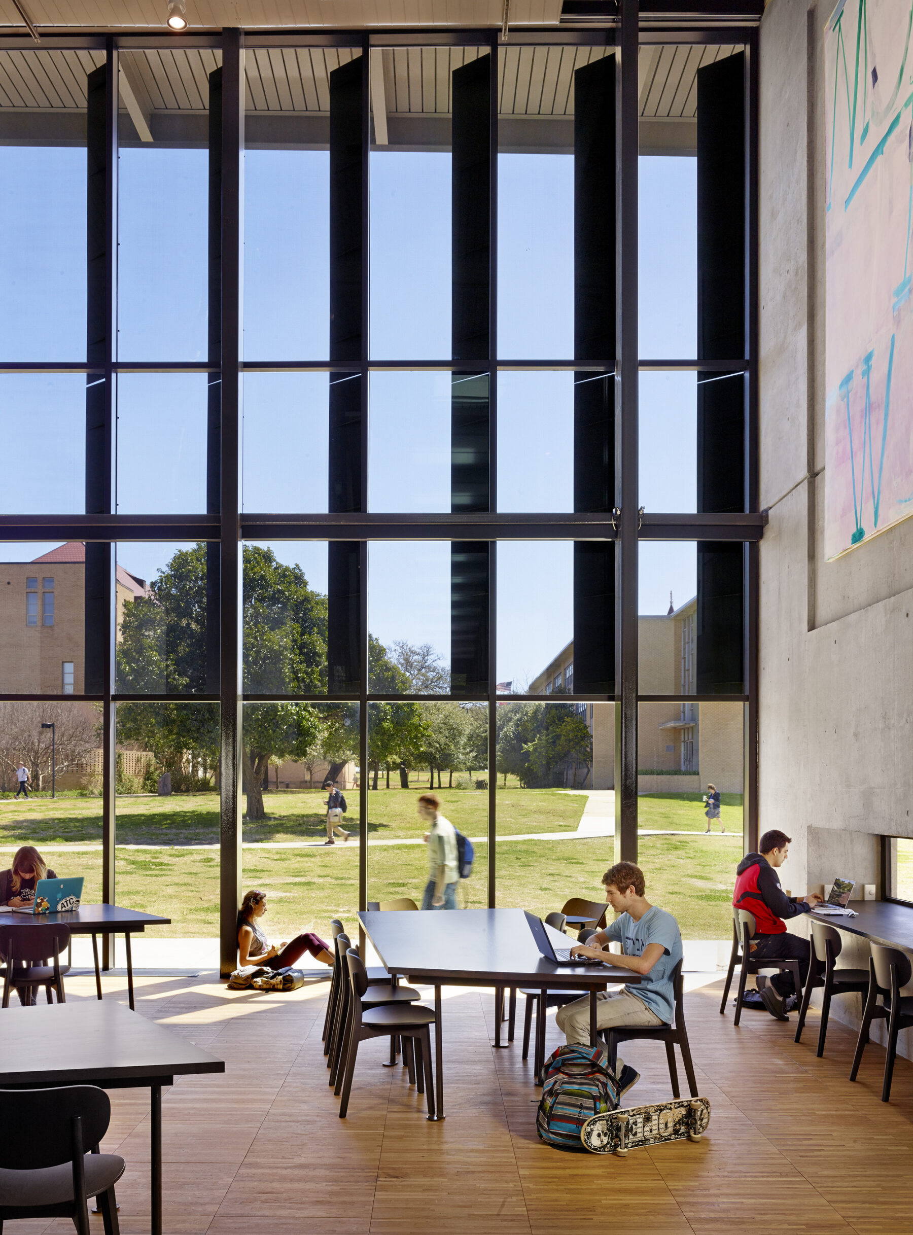 photograph of indoor study room featuring floor to ceiling glass panes