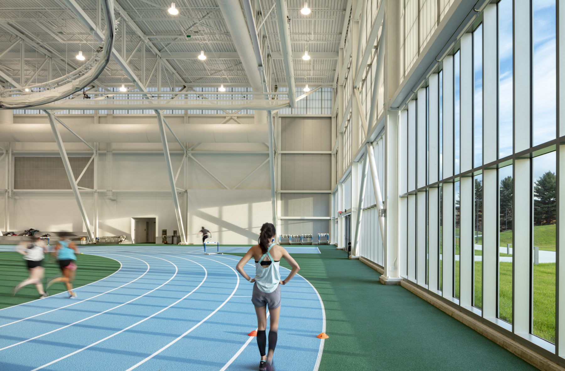 interior photo of field house. Runners move along the track