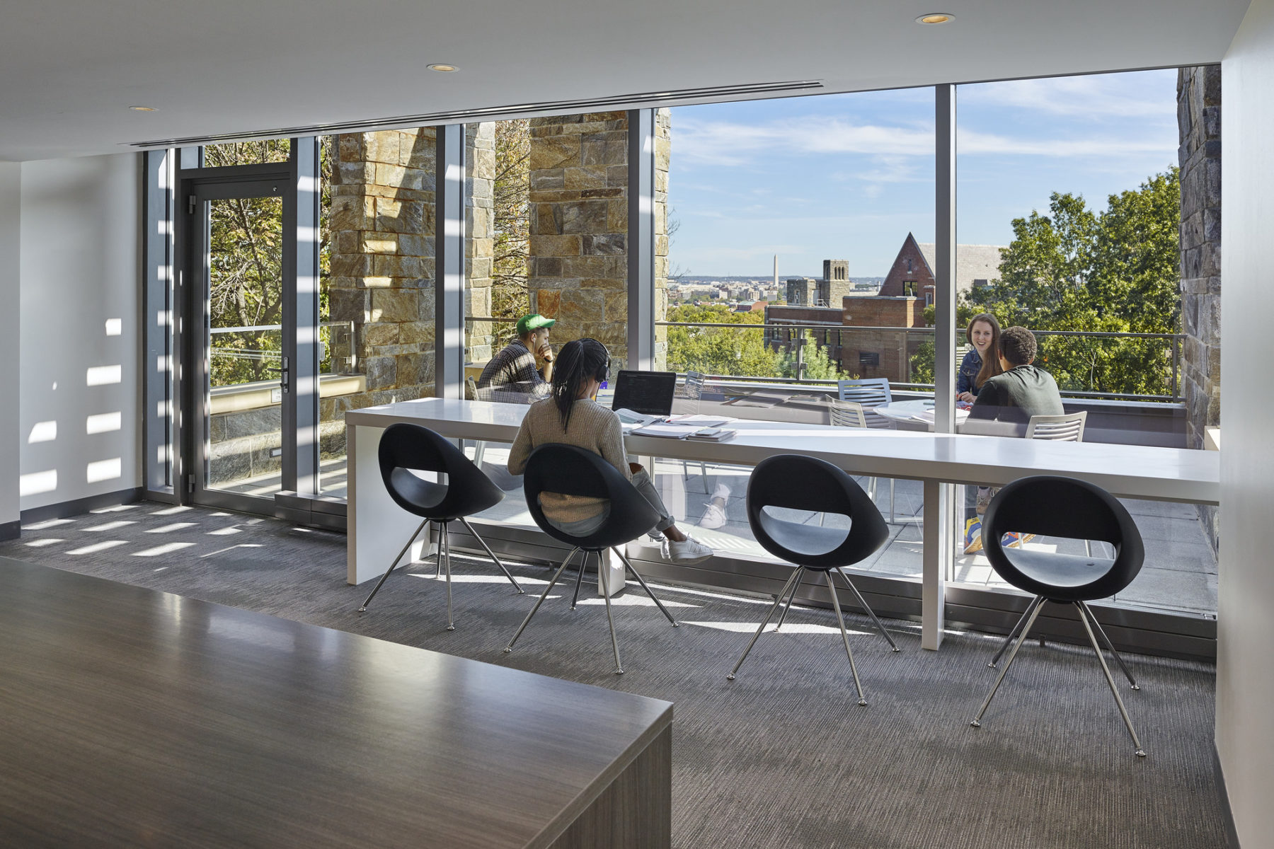 Student sitting at a studyspace near a window