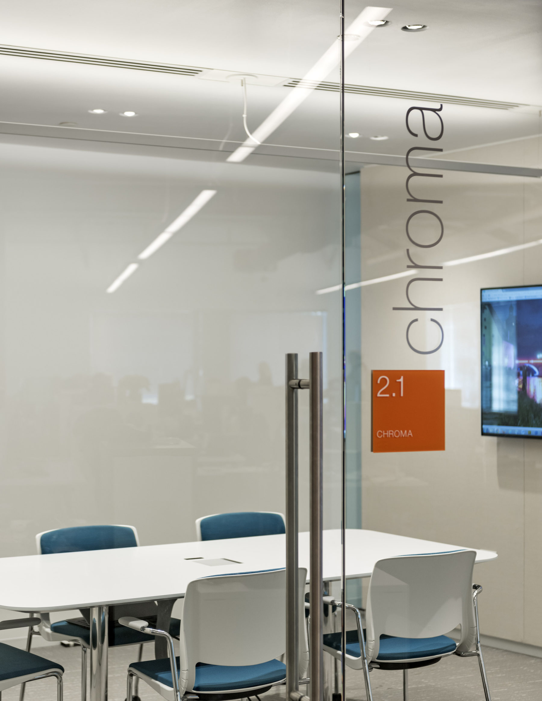a glass door that enters into a conference room