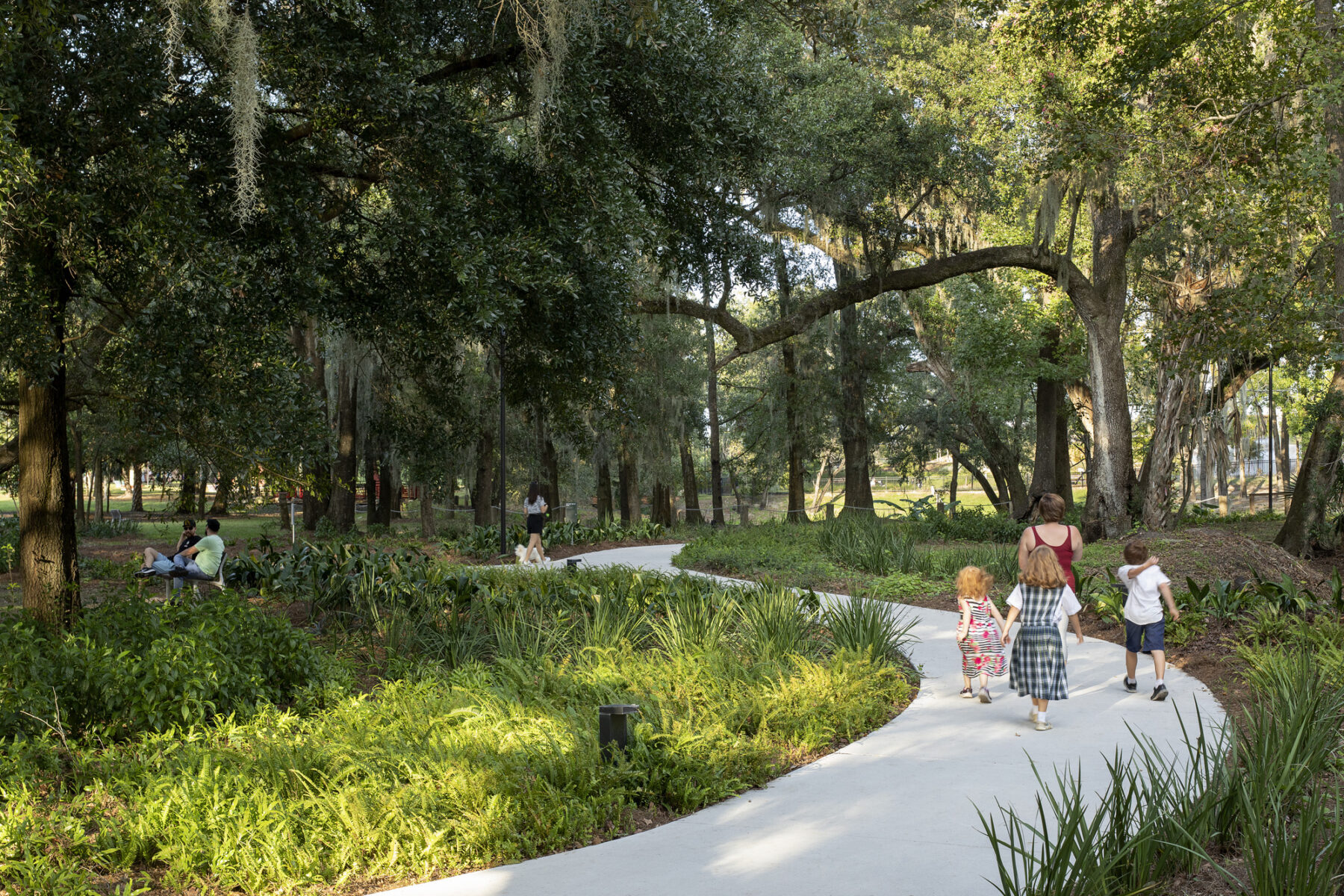 Mother and child walking through Heritage Garden featuring pollinator paths and fruit trees