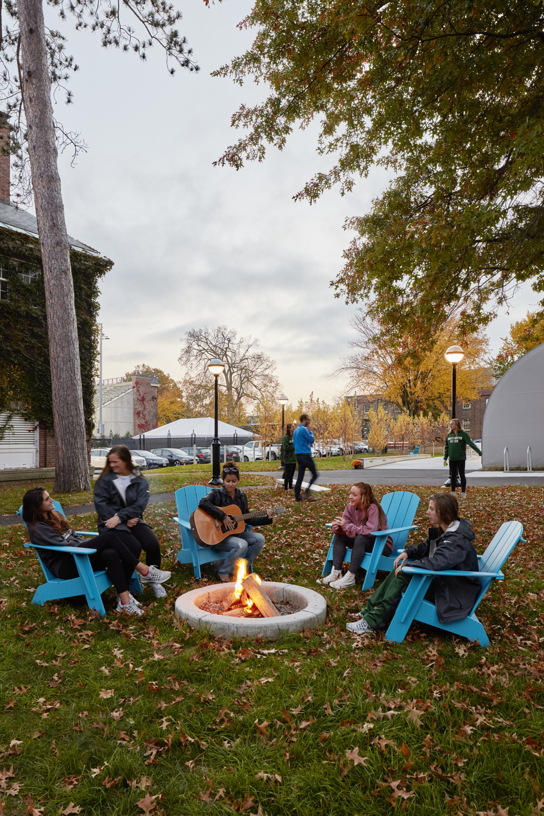 students sit around a fire pit