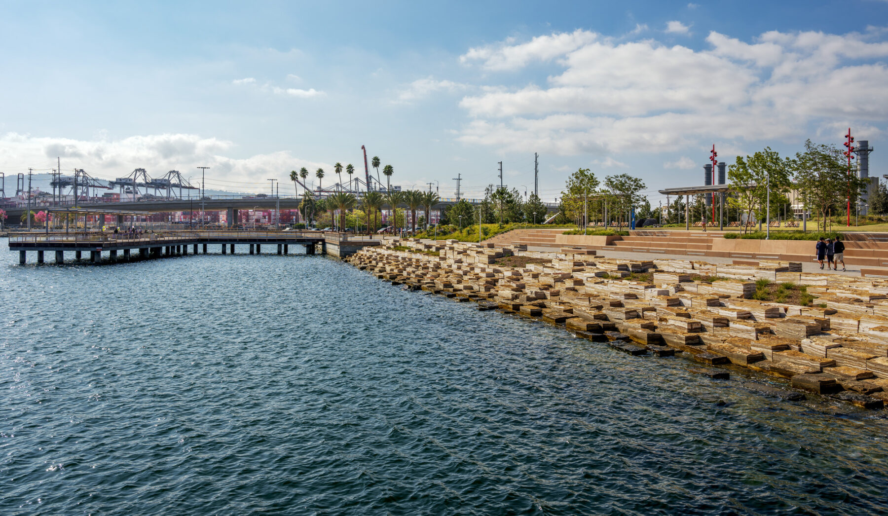 View of the Promenade tidal stones along the waterfront with repeated texture on the water and the stones, and view of Port in background